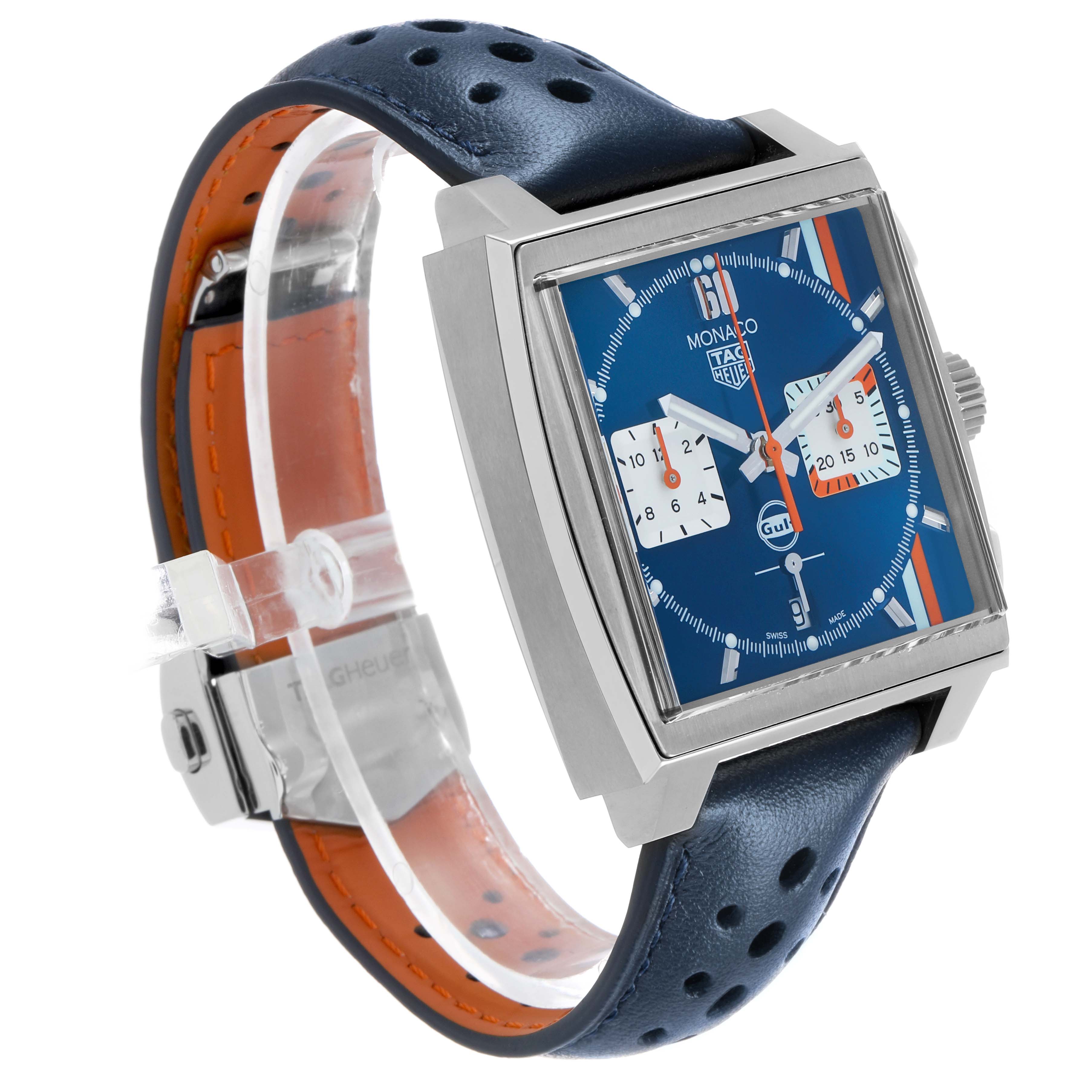 The Tag Heuer Monaco CBL2115 Men's Stainless Steel Blue Dial watch is shown at an angle highlighting its square face, blue dial, and perforated leather strap.
