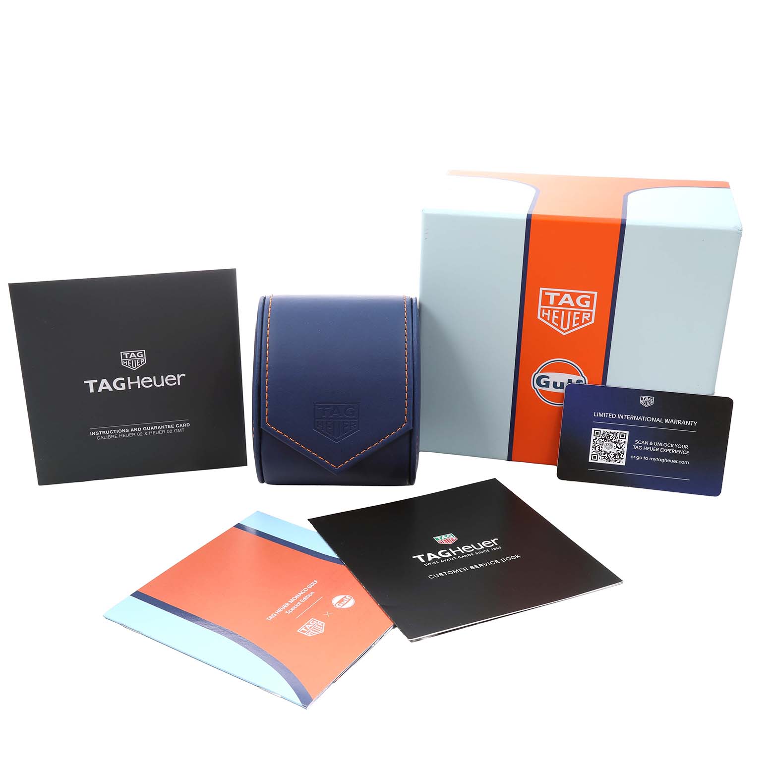The image shows the Tag Heuer Monaco CBL2115 Men's Stainless Steel Blue Dial packaging, including a box, warranty card, manuals, and a watch case.