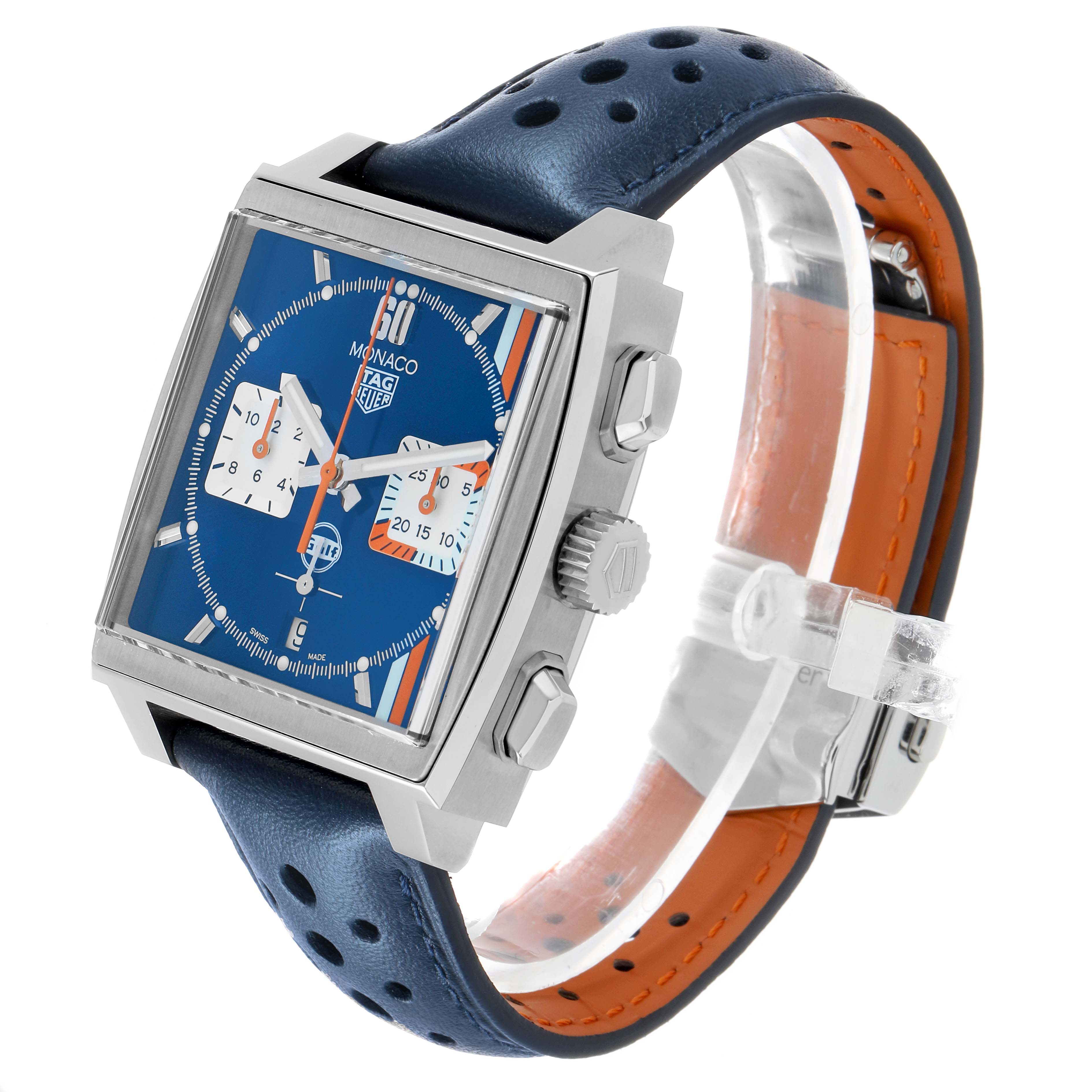 The Tag Heuer Monaco CBL2115 Men's Stainless Steel Blue Dial watch is shown at an angled view, highlighting the face, case, crown, and perforated blue strap.