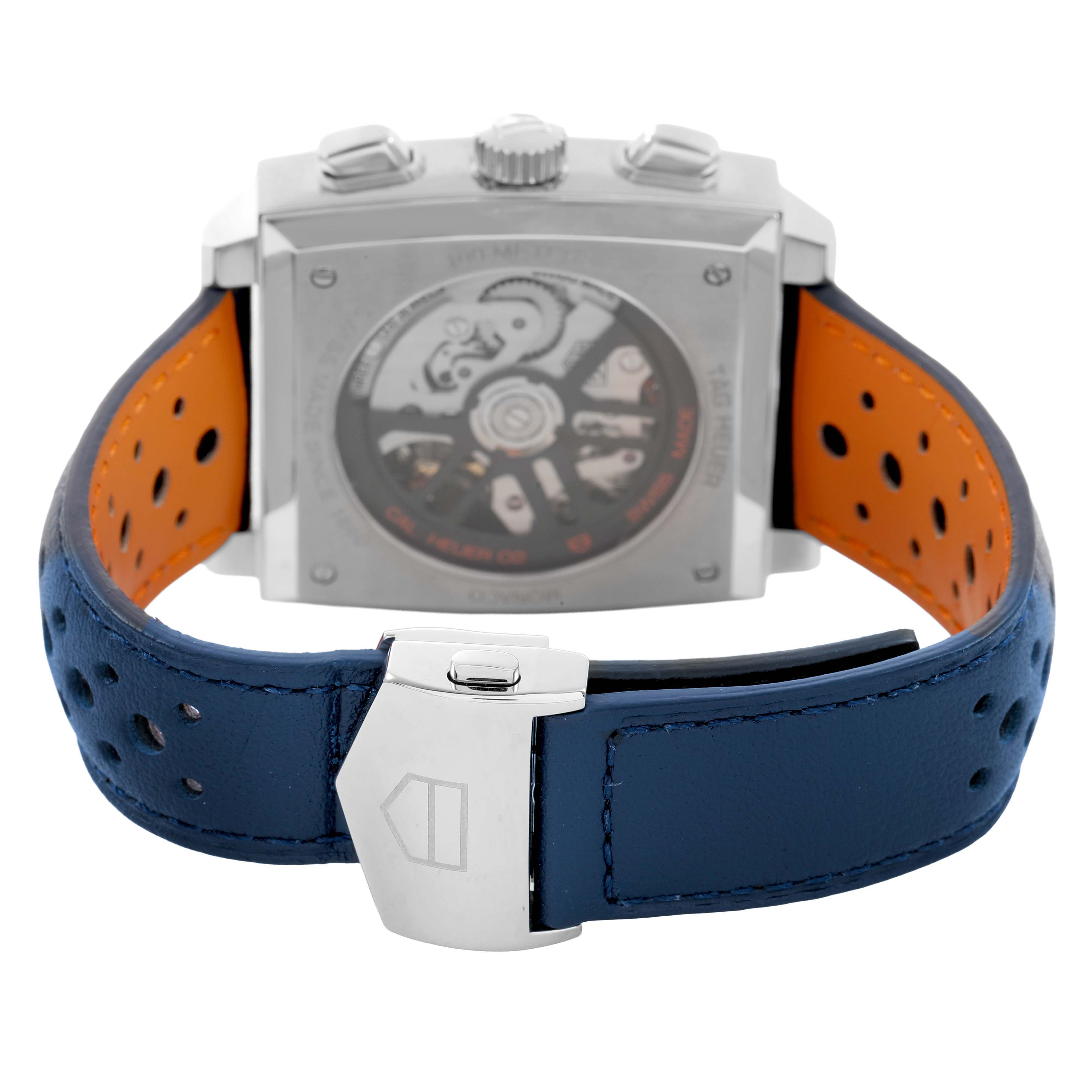 The image shows the back view of a Tag Heuer Monaco CBL2115 Men's Stainless Steel Blue Dial watch, featuring the movement and perforated blue leather strap.