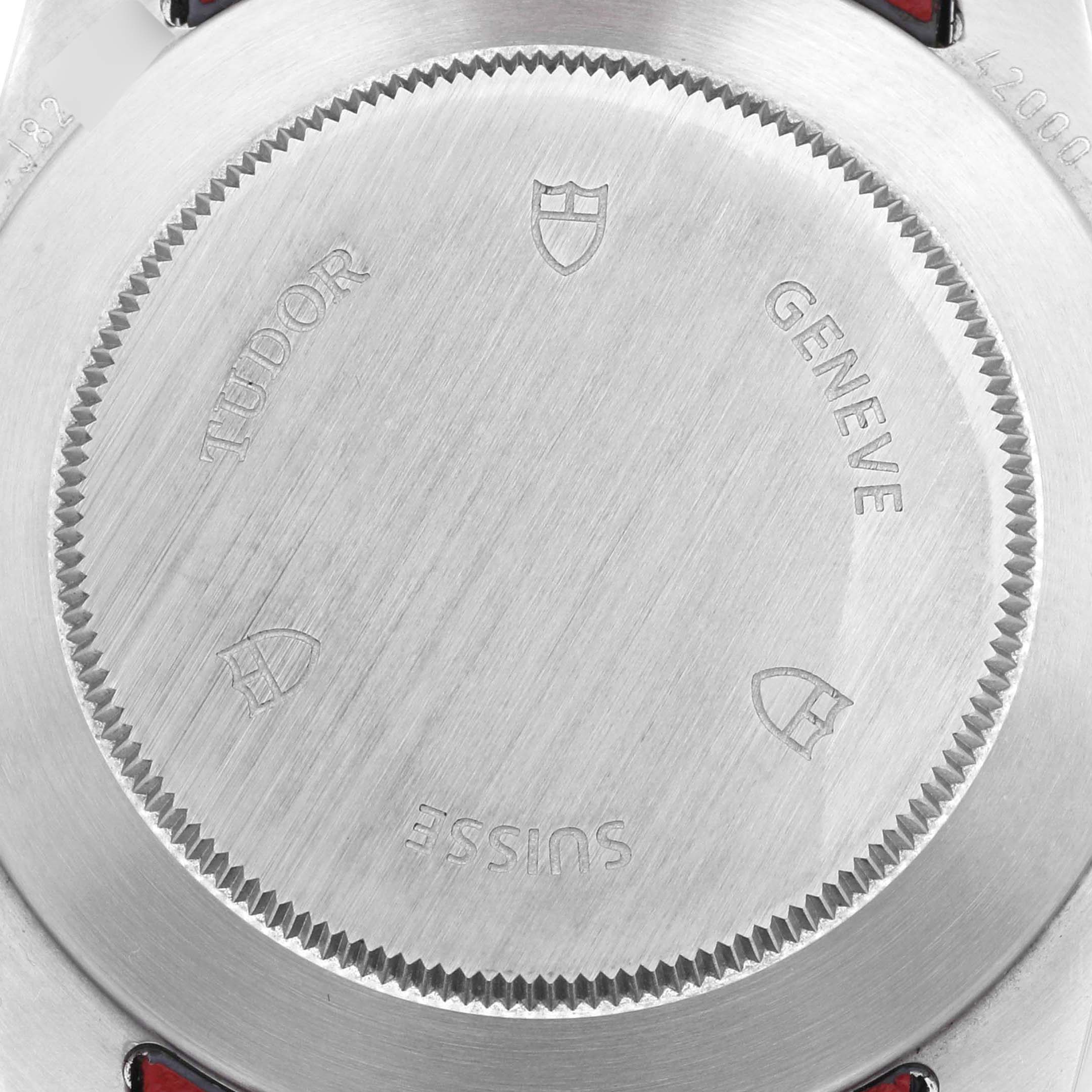 The image shows the case back of the Tudor Fastrider 42000D Men's Stainless Steel Red Dial 42000D Men's Stainless Steel Red Dial model watch with engravings including "Tudor" and "Geneve".