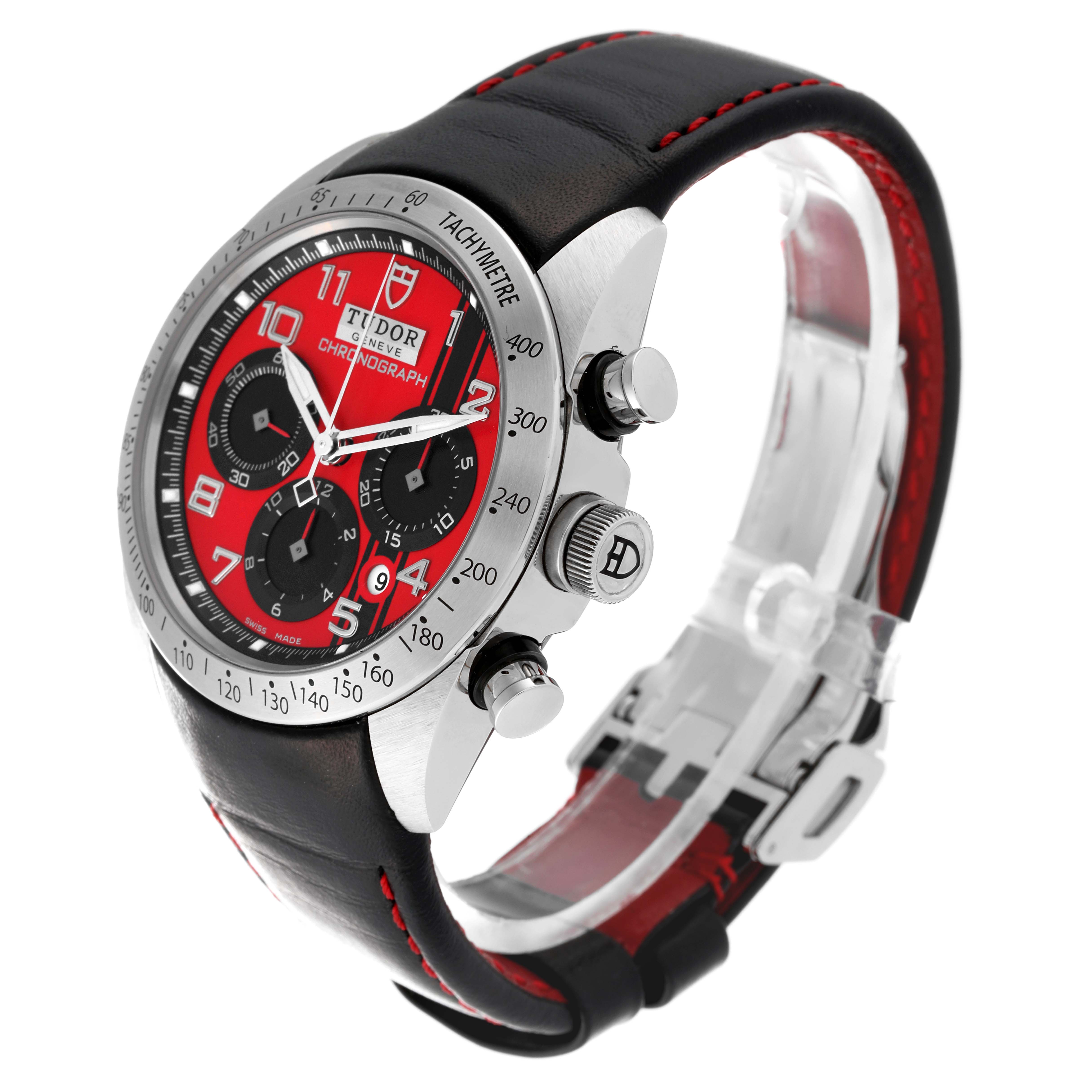 The image shows a Tudor Fastrider 42000D Men's Stainless Steel Red Dial 42000D Men's Stainless Steel Red Dial watch at an angled view, highlighting the face, bezel, crown, and leather strap.