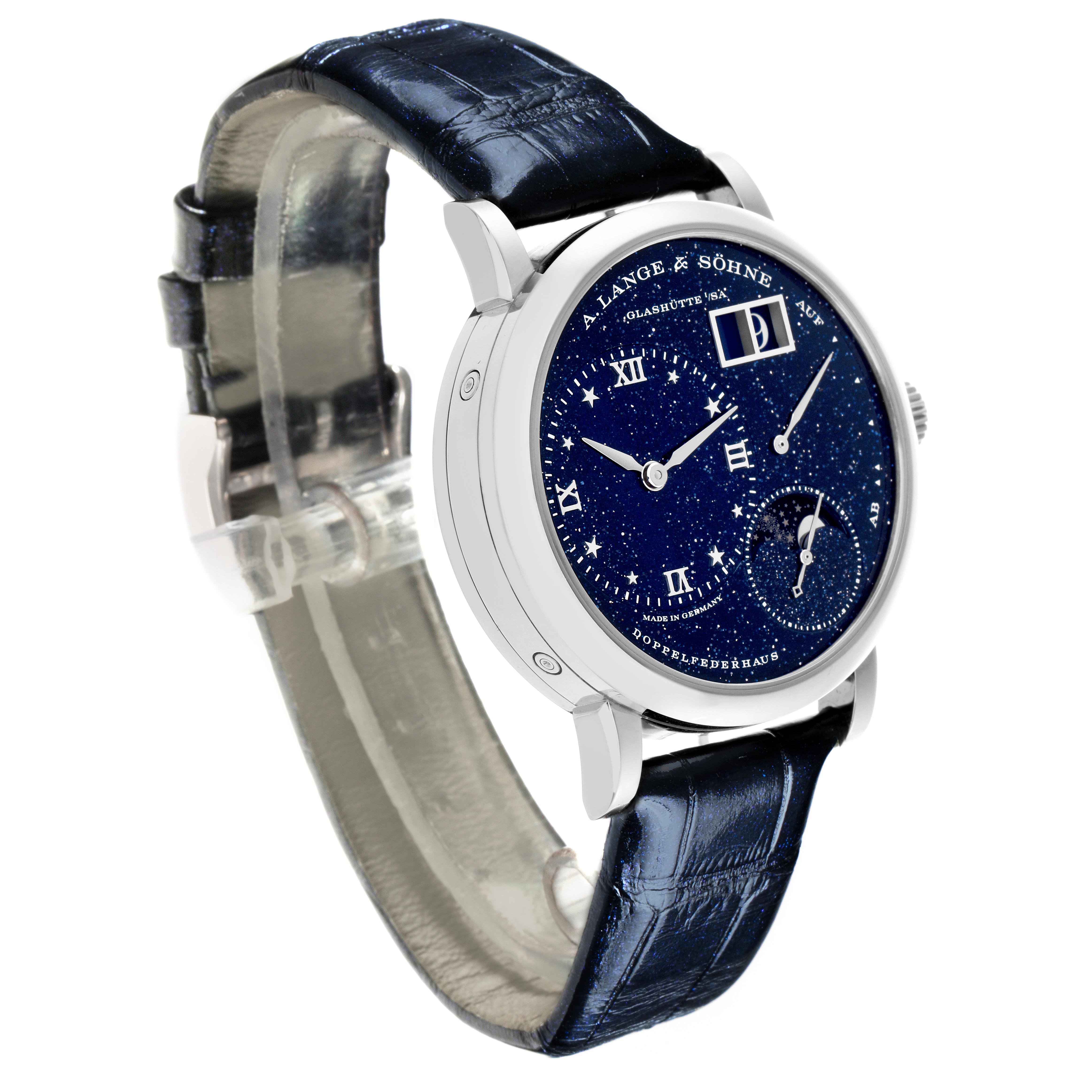 The A. Lange & Sohne Lange 1 182.086/LSLS823AX Men's White Gold Blue Dial watch is shown at a front angle, highlighting the dazzling dial and the blue alligator strap.