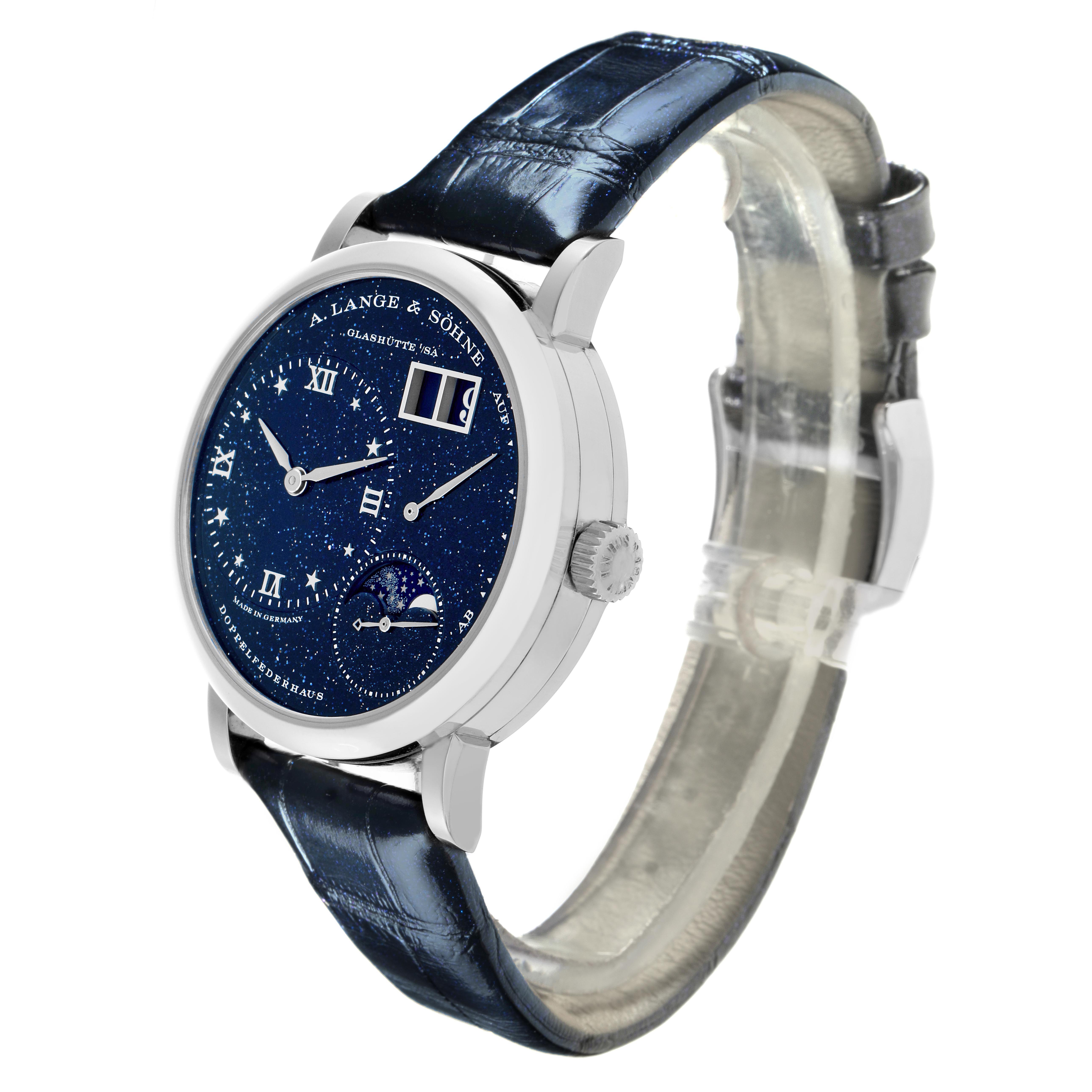 The image shows an A. Lange & Sohne Lange 1 182.086/LSLS823AX Men's White Gold Blue Dial watch at a three-quarter angle, highlighting the watch face, case, crown, and strap.