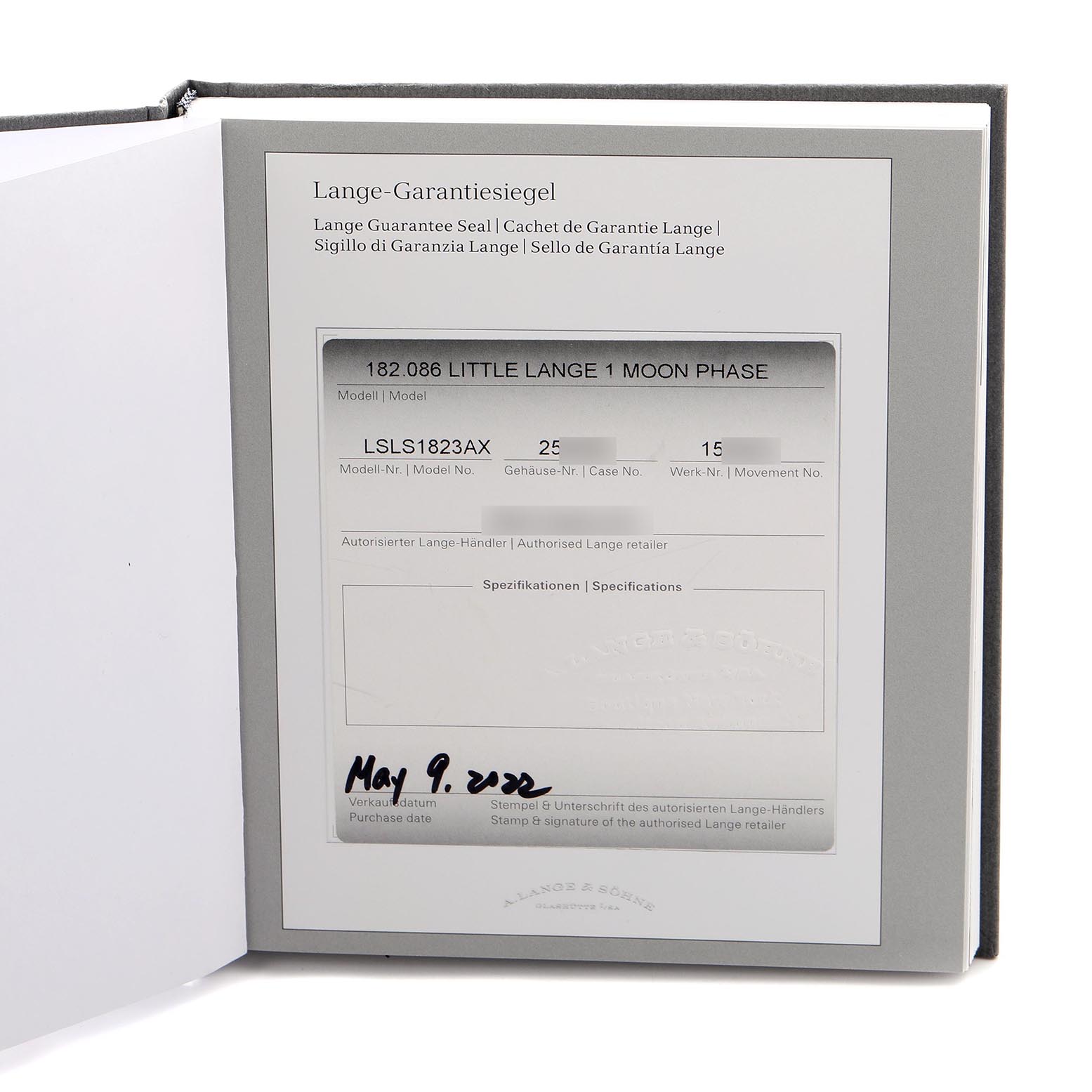 The image shows the Lange 1 model's guarantee seal card by A. Lange & Söhne in a booklet.