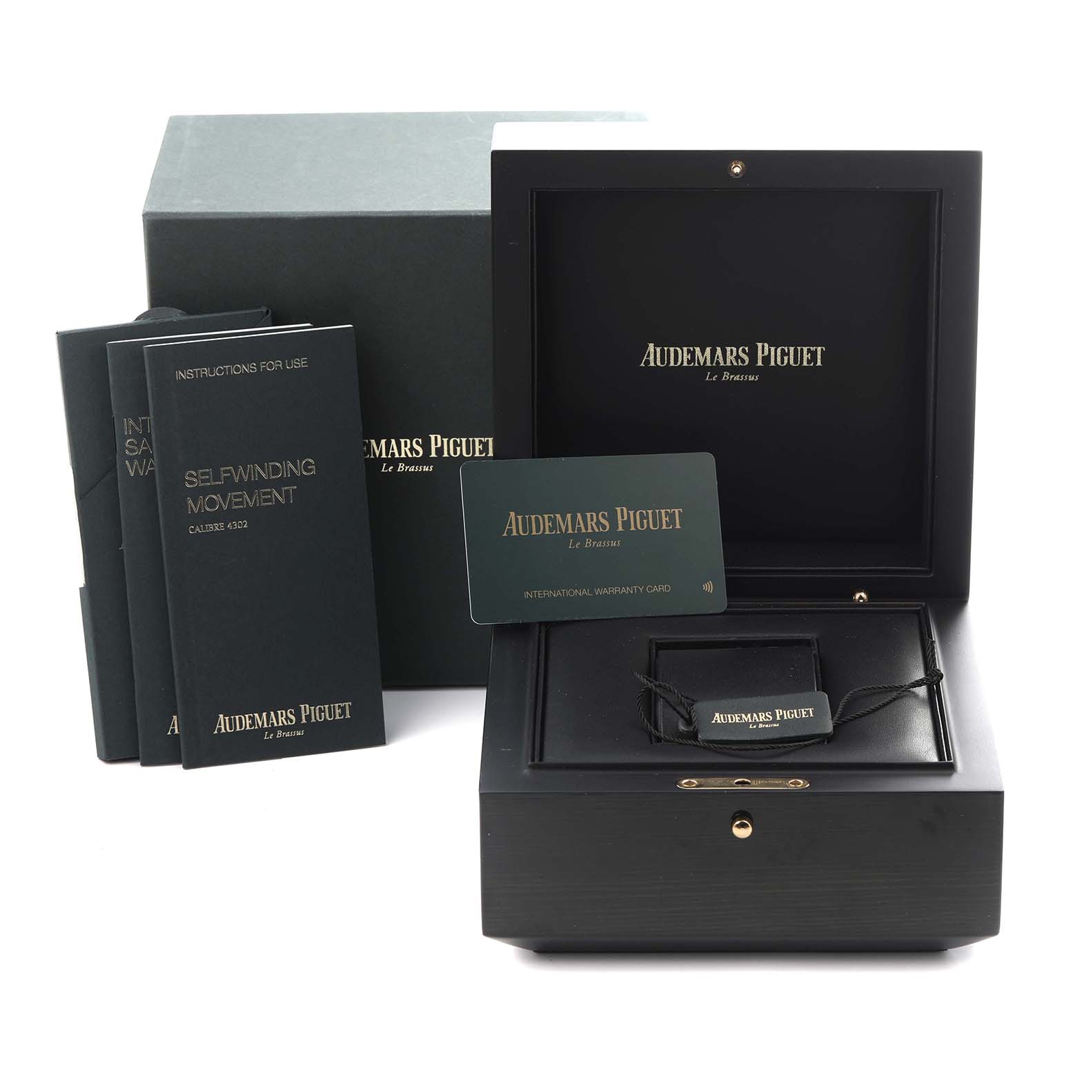 The image shows the packaging and accessories for an Audemars Piguet Royal Oak 15500ST.OO.1220ST.03 Men's Stainless Steel Black Dial 15500ST.OO.1220ST.03 Men's Stainless Steel Black Dial, including boxes, manuals, and a warranty card.