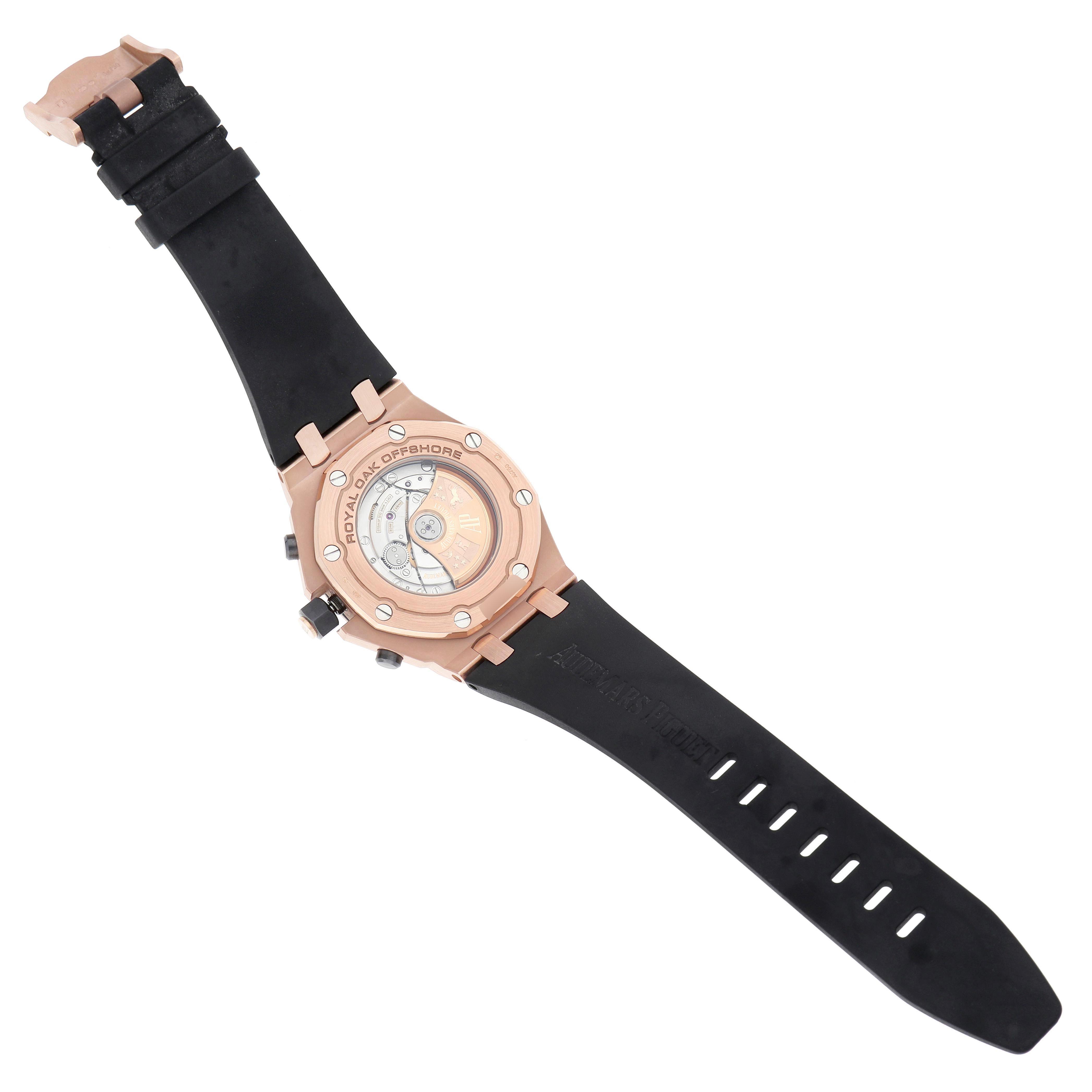 The image shows the back of the Audemars Piguet Royal Oak Offshore 26470OR.OO.A125CR.01.A Men's Rose Gold Grey Dial 26470OR.OO.A125CR.01.A Men's Rose Gold Grey Dial watch, highlighting its case back and rubber strap.