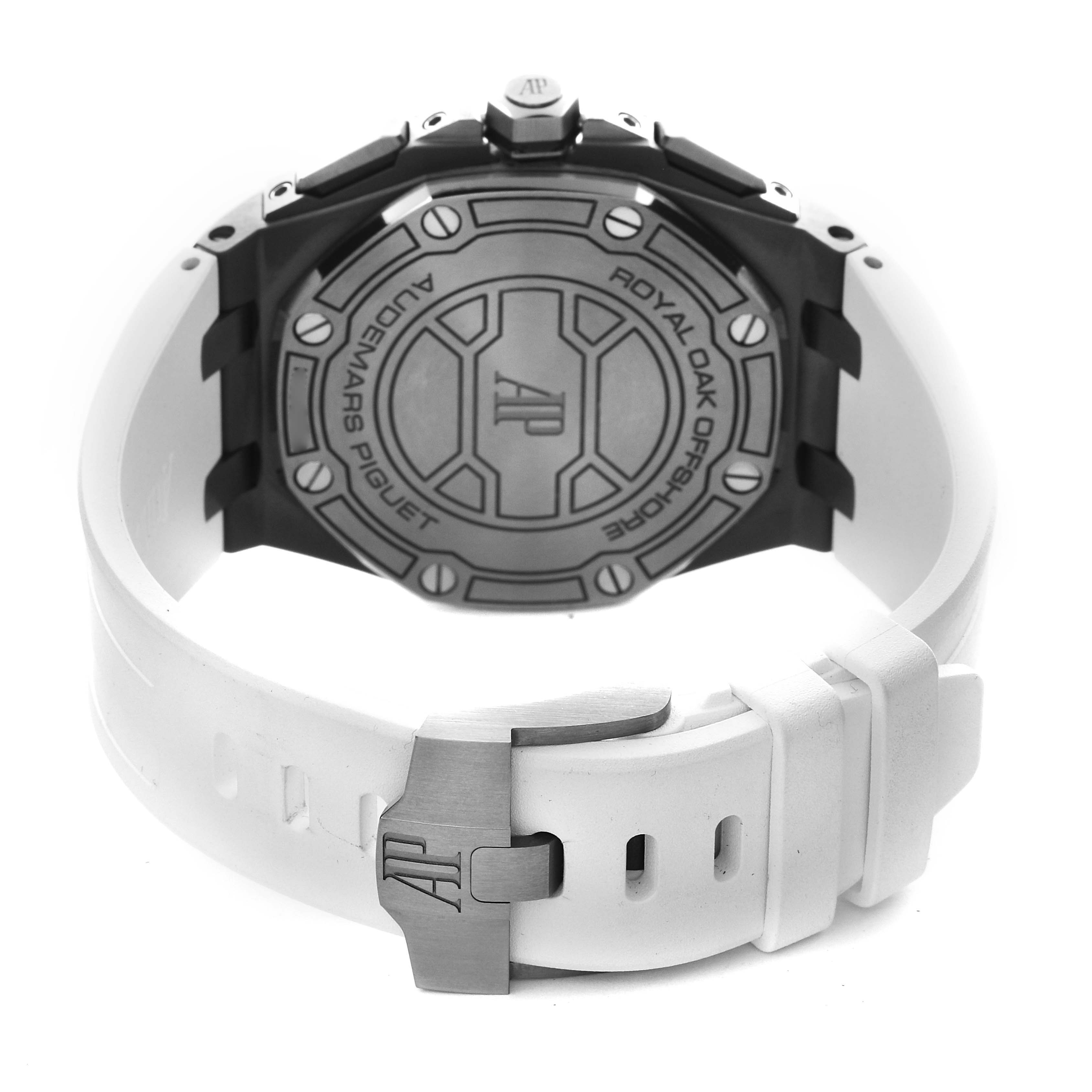 The image shows the back of the Audemars Piguet Royal Oak Offshore 26480TI.OO.A027CA.01 Men's Titanium Blue Dial 26480TI.OO.A027CA.01 Men's Titanium Blue Dial watch, highlighting the case back and white rubber strap.