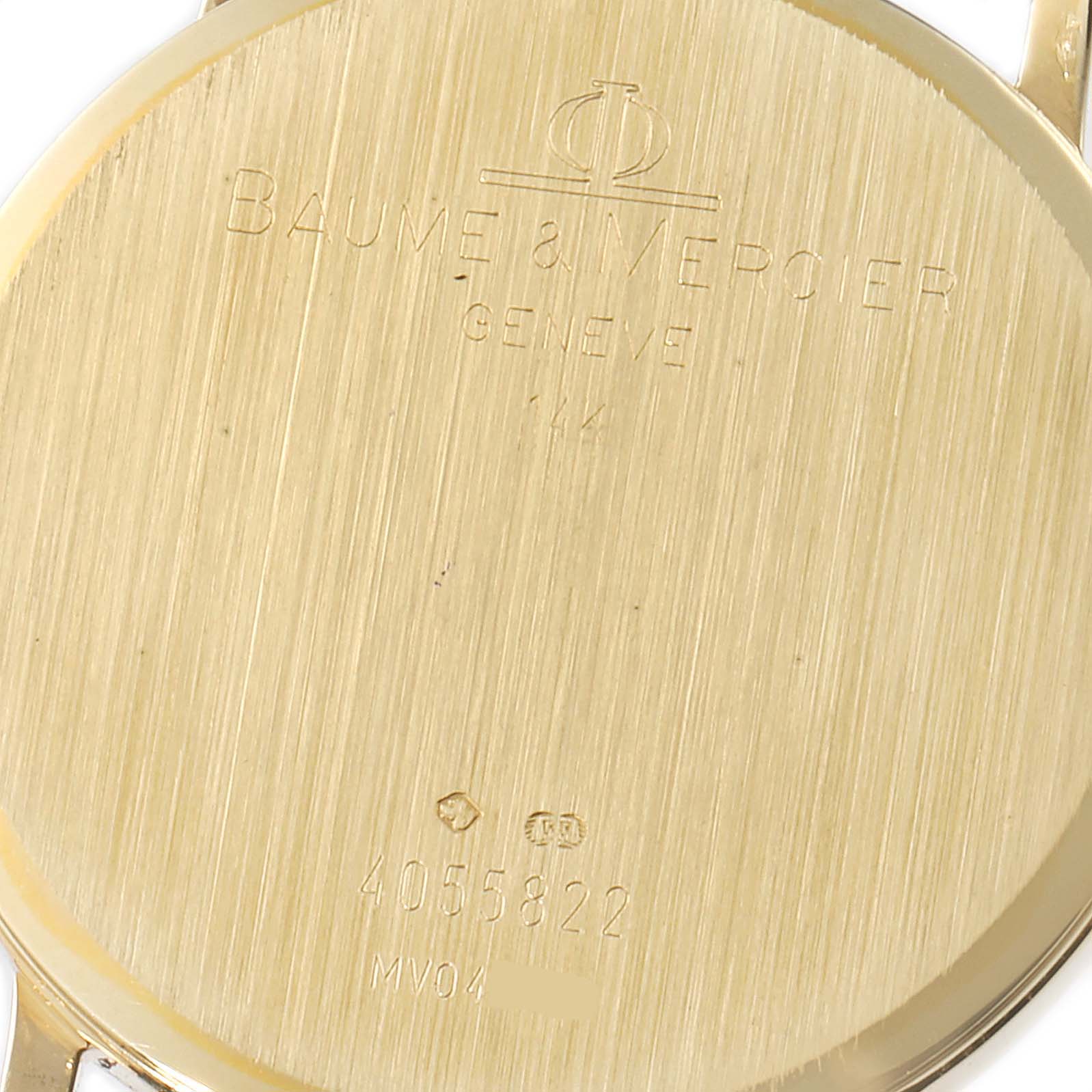 This is a close-up of the back case of a Baume & Mercier Classima MV045093 Men's Yellow Gold White Dial MV045093 Men's Yellow Gold White Dial watch showing the brand's engraved details.