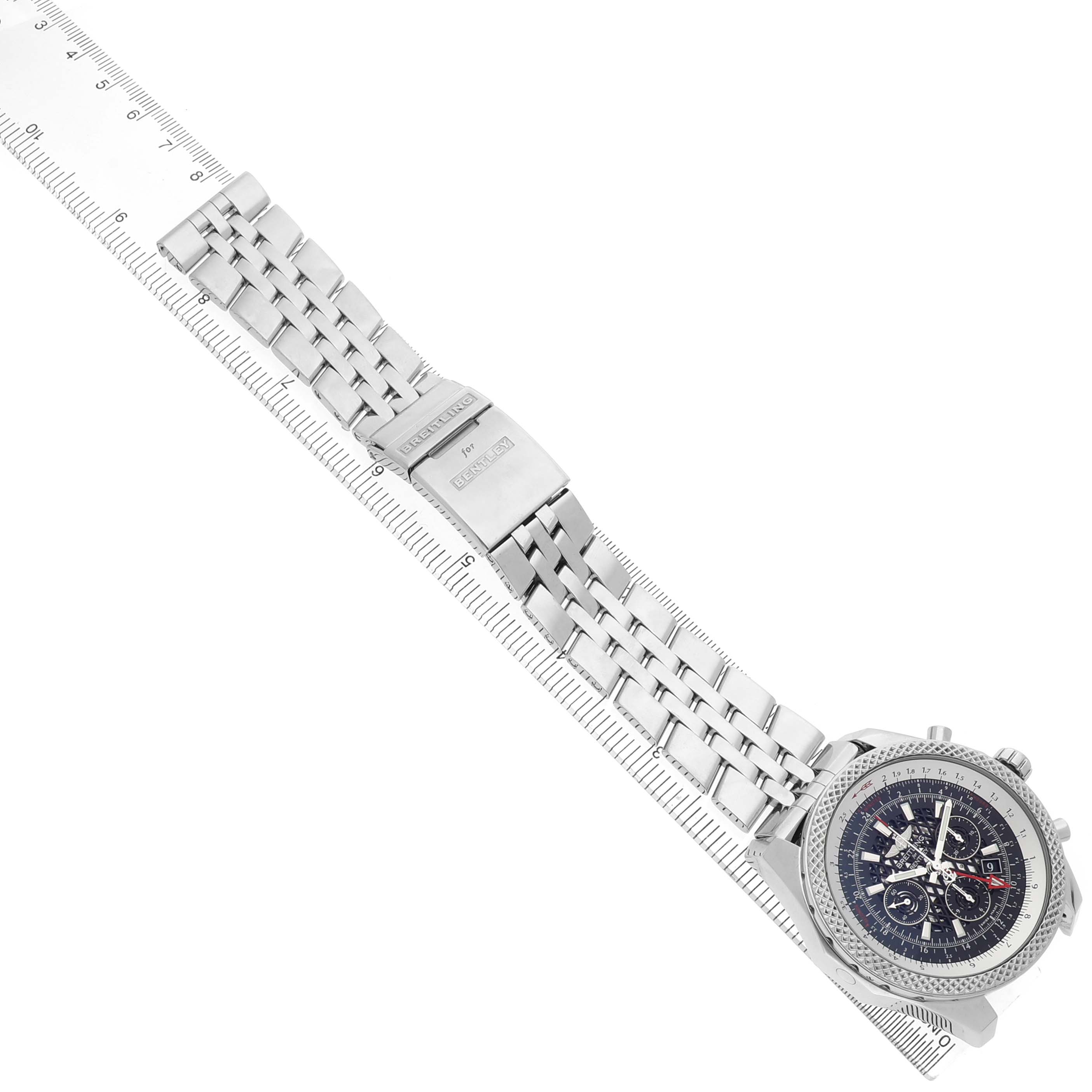 The Breitling Bentley AB0431 Men's Stainless Steel Black Dial watch is shown at a diagonal angle, displaying the dial, bracelet, and clasp alongside a ruler.