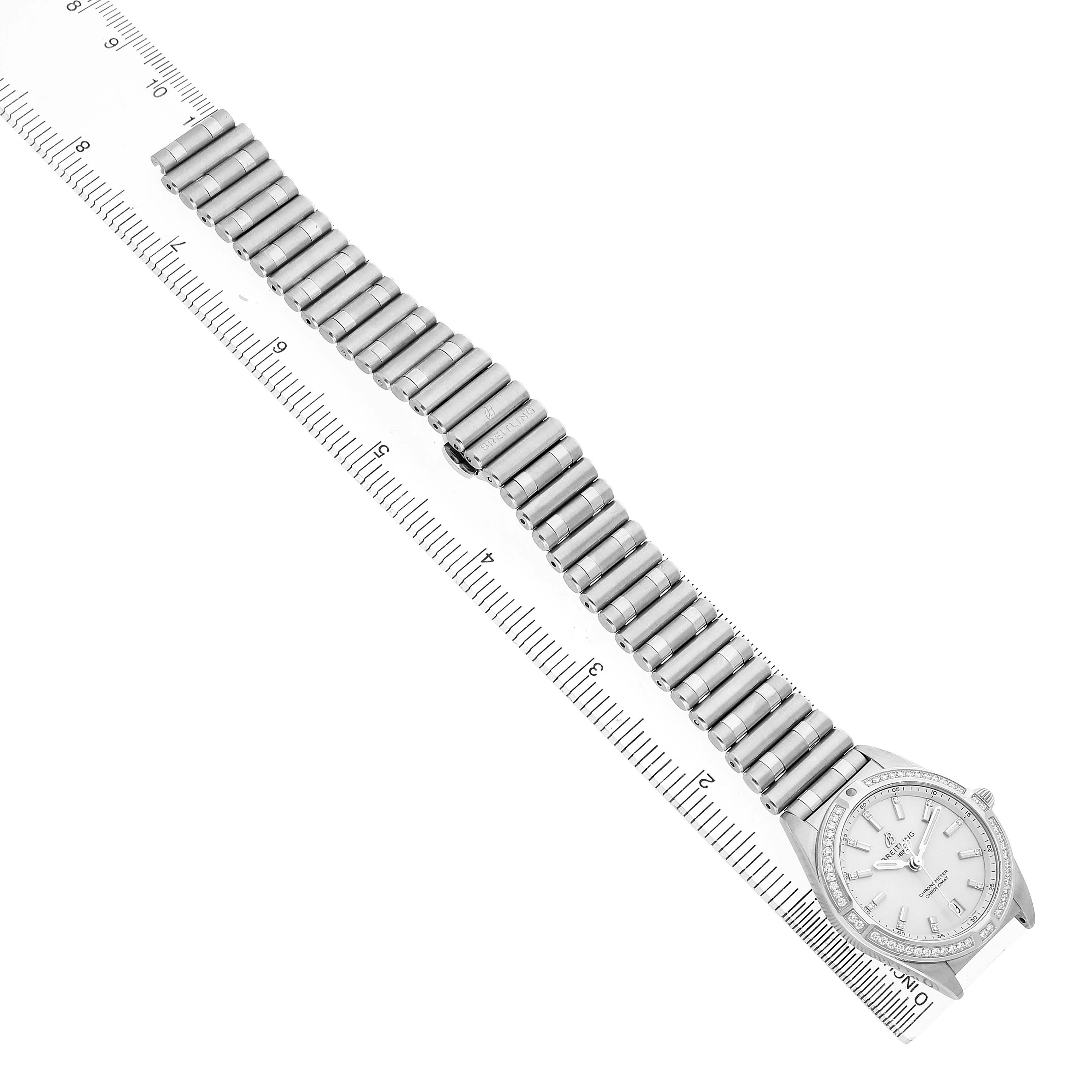 The Breitling A77310591A1A1 Women's Stainless Steel Silver Dial Chronomat 32 Silver Diamond Steel Ladies Watch is shown from a top view, displaying the face, band, and surrounding ruler.