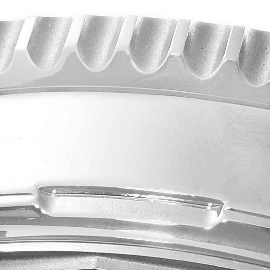 This image shows a close-up of the bezel and case of a Breitling Navitimer A19380 Men
s Stainless Steel Black Dial A19380 Men
s Stainless Steel Black Dial watch, highlighting the ridged edge and part of the serial number.