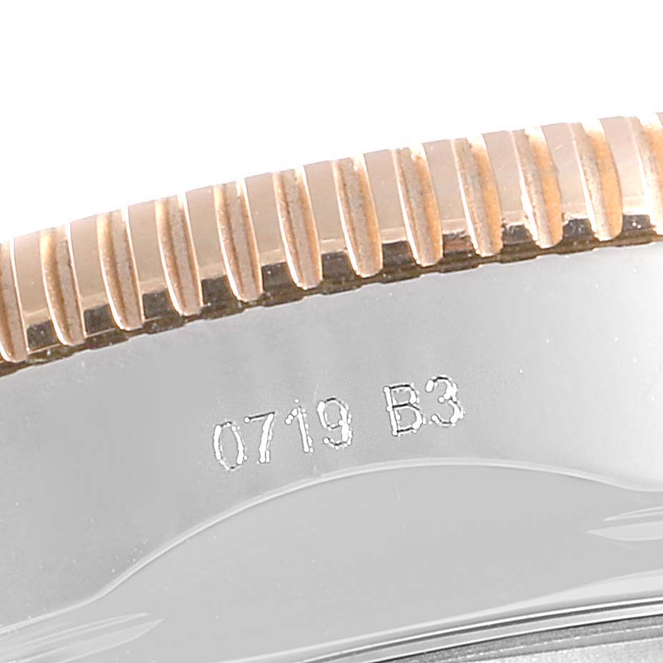 This image shows a close-up view of the side of the bezel on a Breitling Superocean UB201012/BG53/154A Men
s Stainless Steel Black Dial UB201012/BG53/154A Men
s Stainless Steel Black Dial watch, featuring serrated edges and a partial serial number.