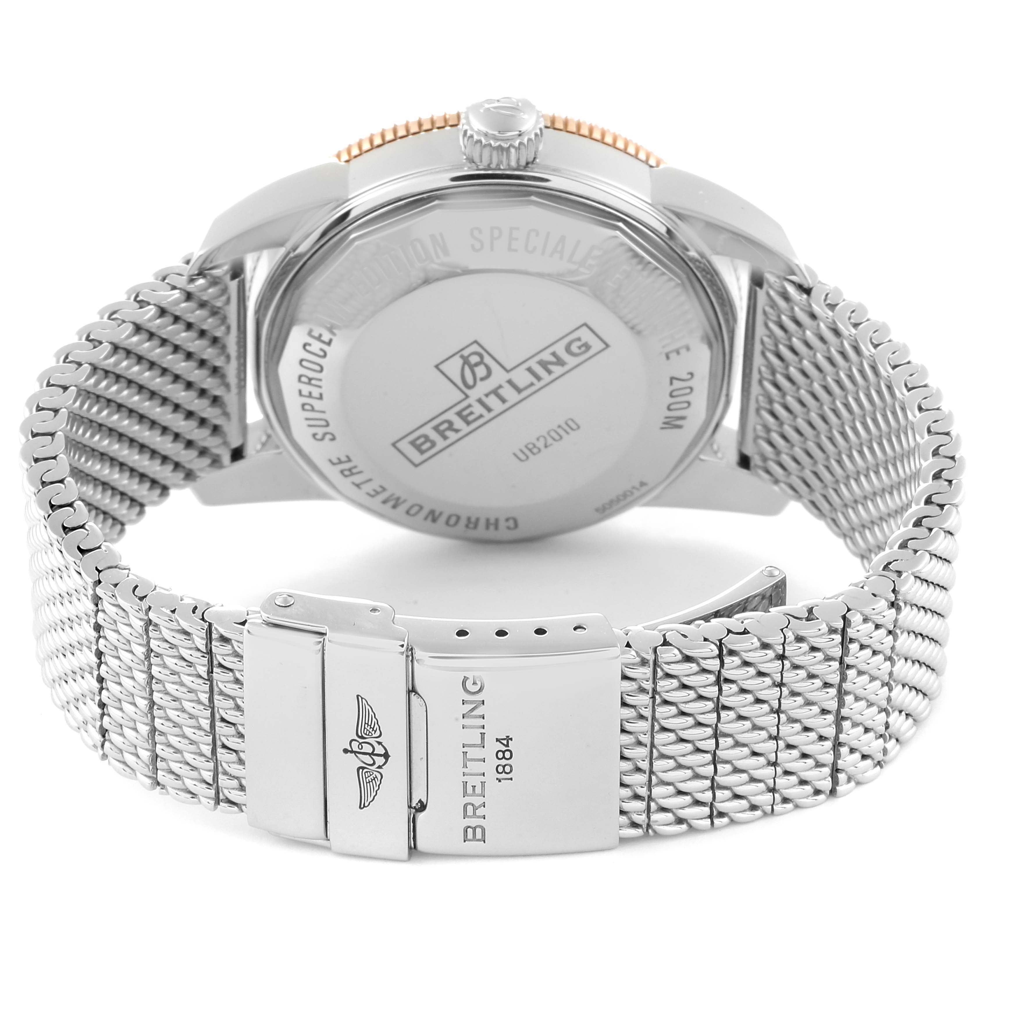 The image shows the back of a Breitling Superocean UB201012/BG53/154A Men
s Stainless Steel Black Dial UB201012/BG53/154A Men
s Stainless Steel Black Dial watch along with its metal mesh band.