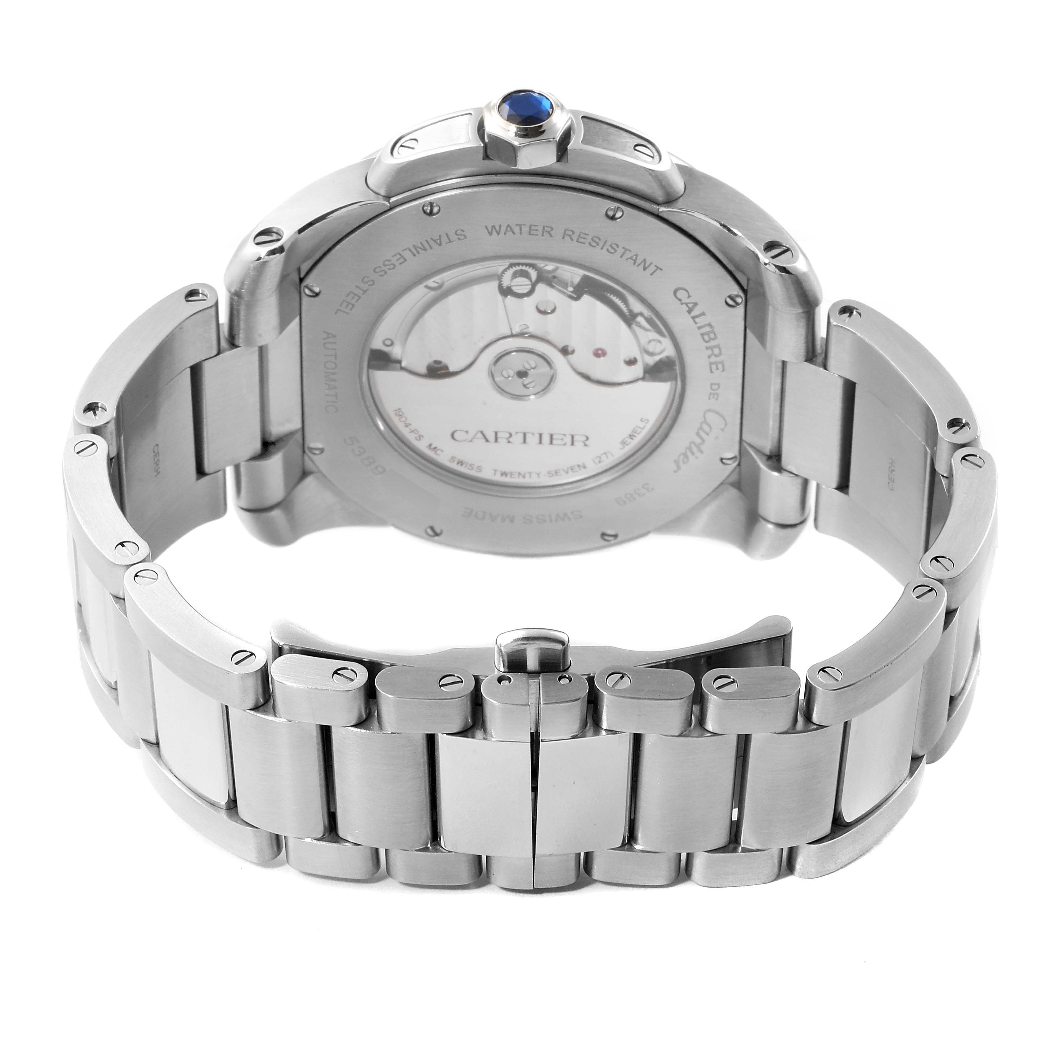 The image shows the back view of a Calibre de Cartier watch by Cartier, highlighting its stainless-steel bracelet and transparent case back.