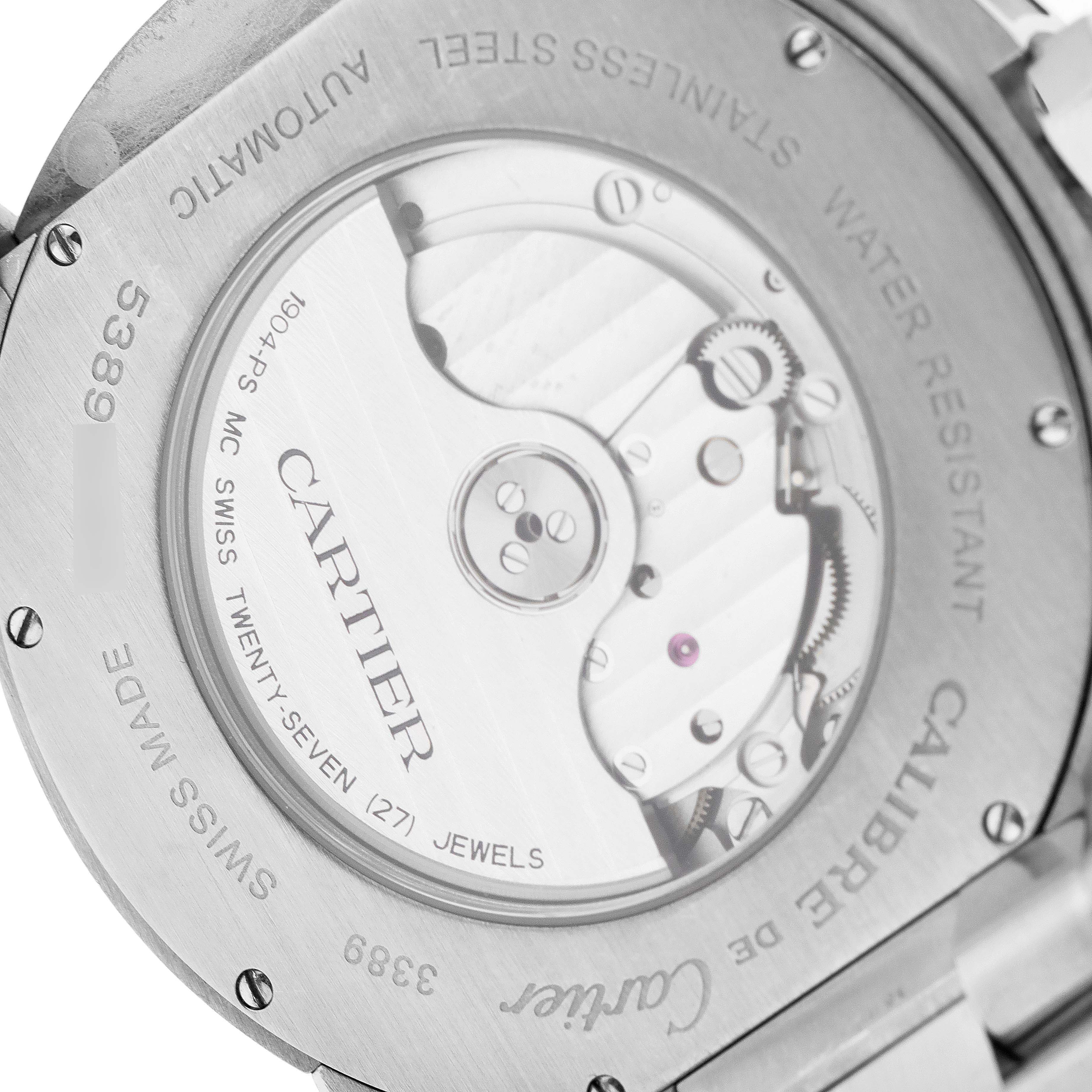 The image shows the back view of a Calibre de Cartier watch by Cartier, highlighting the automatic movement and stainless steel case.