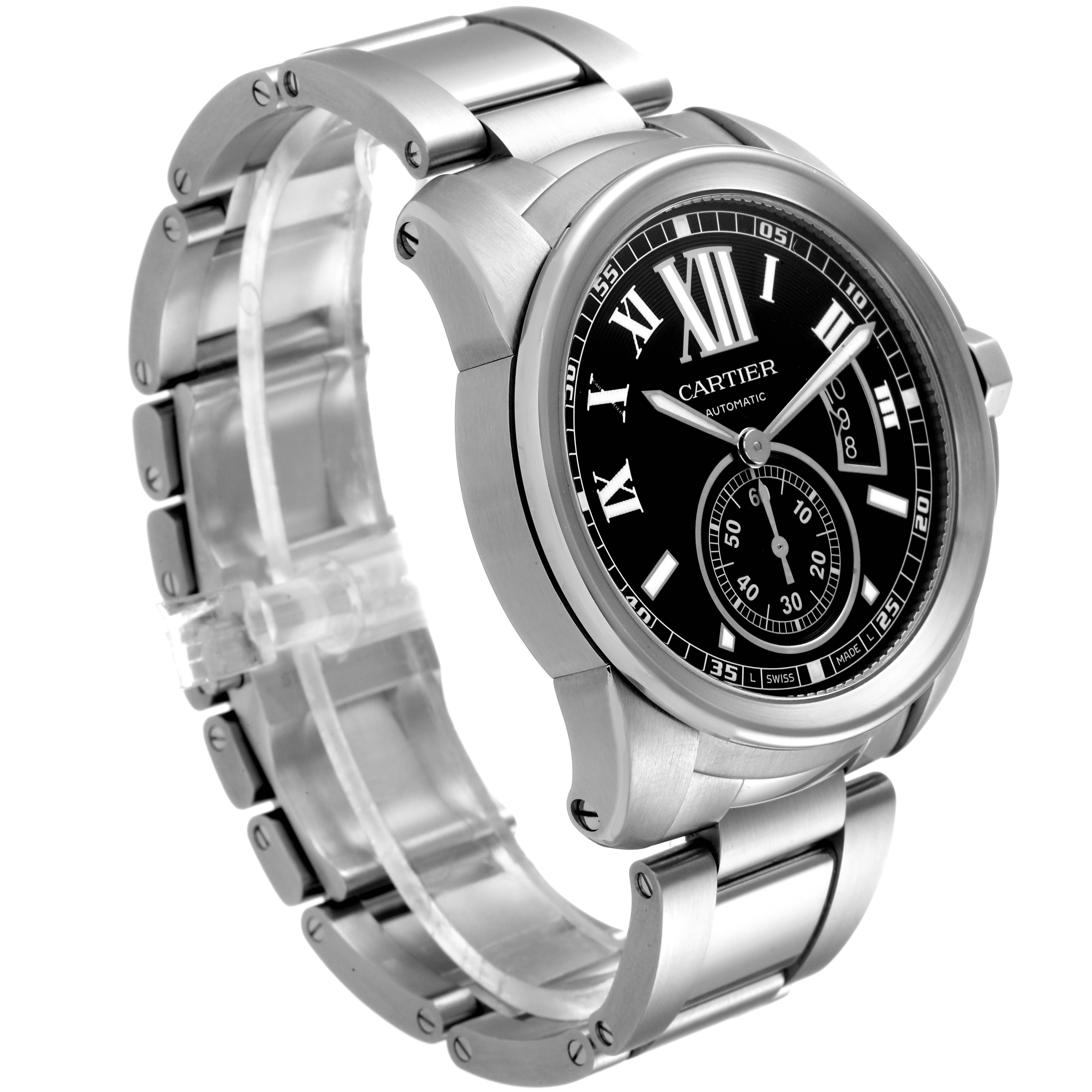 The Calibre de Cartier watch by Cartier is shown at a slight angle, detailing the black dial, Roman numerals, and stainless steel bracelet.