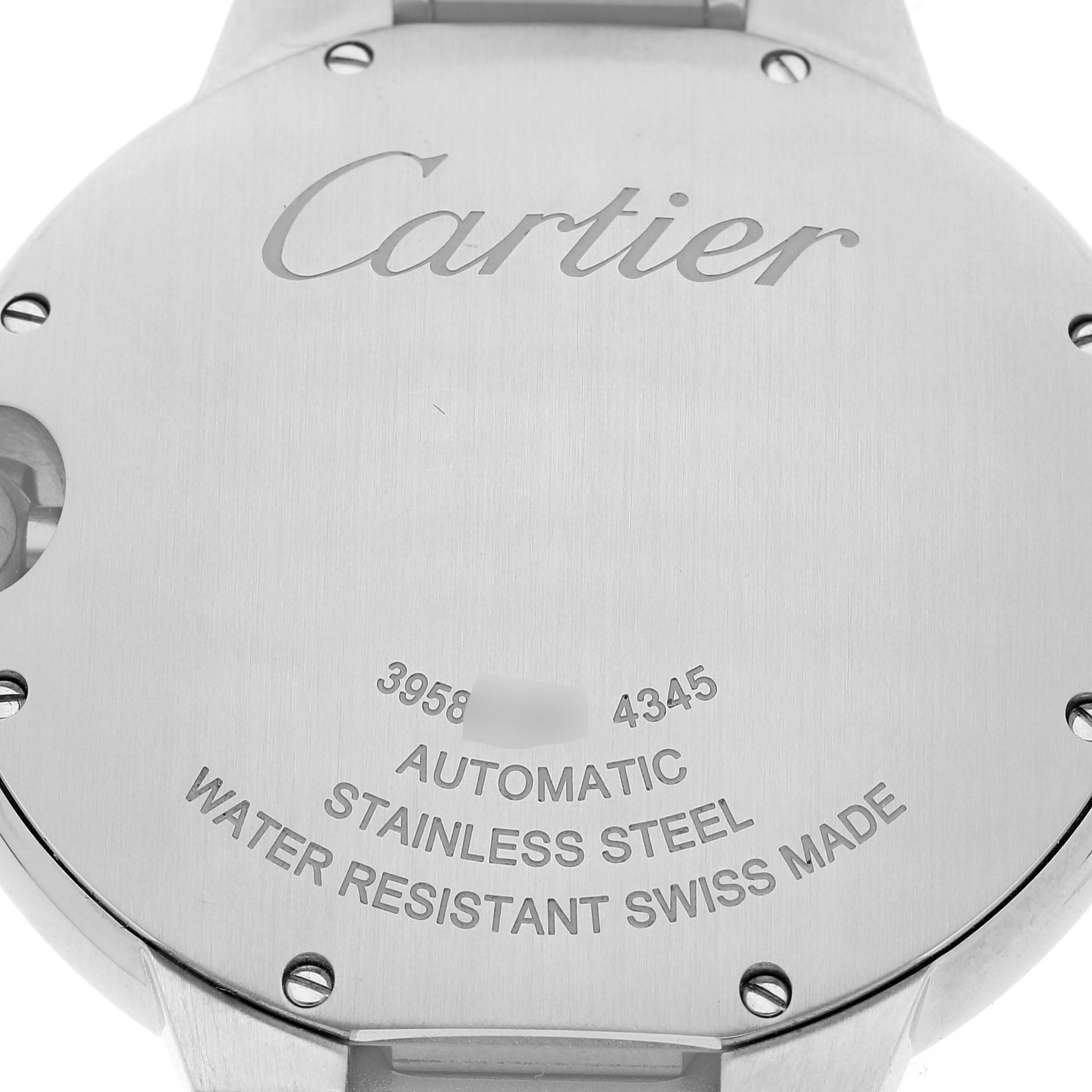 The image shows the back of a Ballon Bleu model by Cartier, highlighting its stainless steel case and engravings.