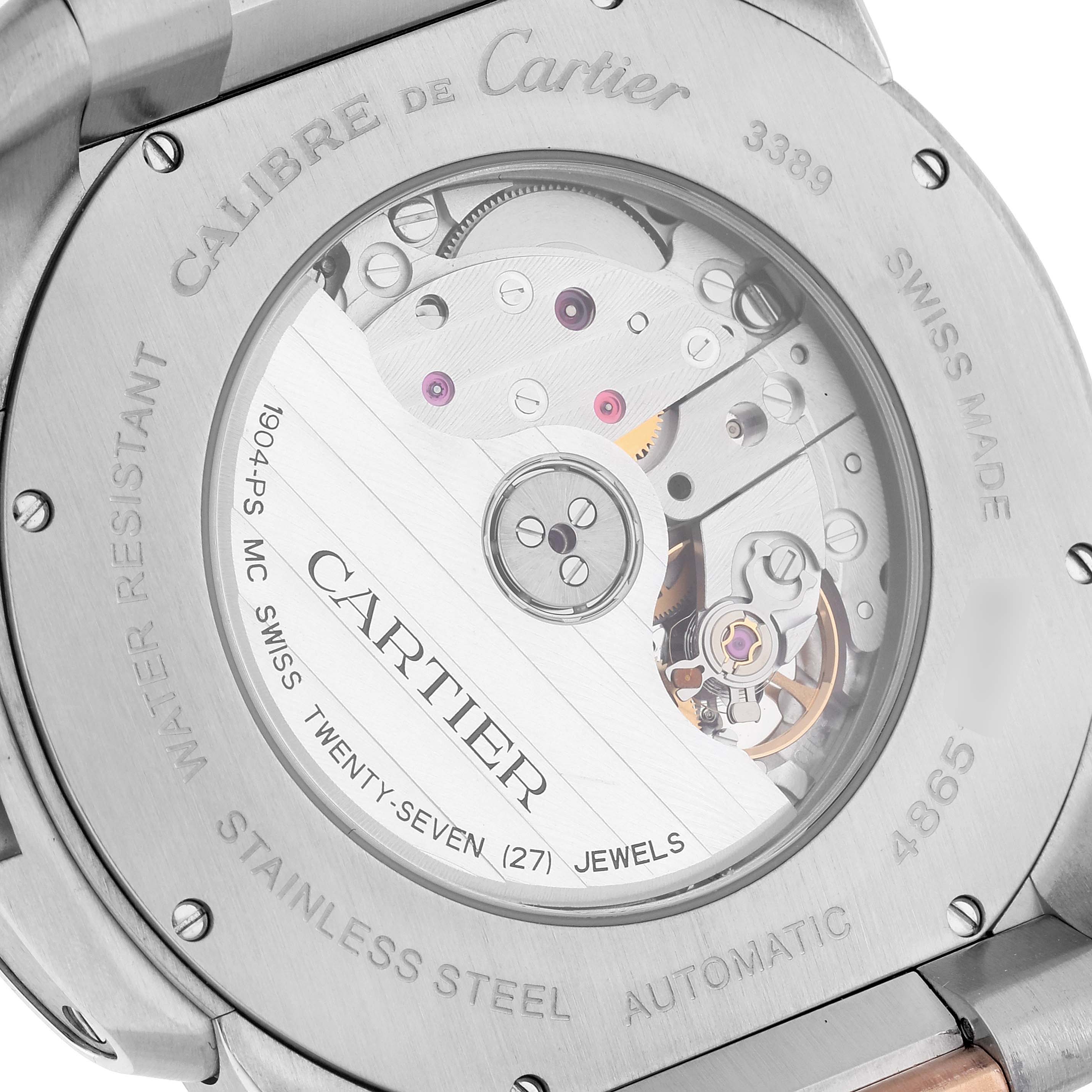 The image shows the back of a Calibre de Cartier watch by Cartier, highlighting its movement and internal mechanics.