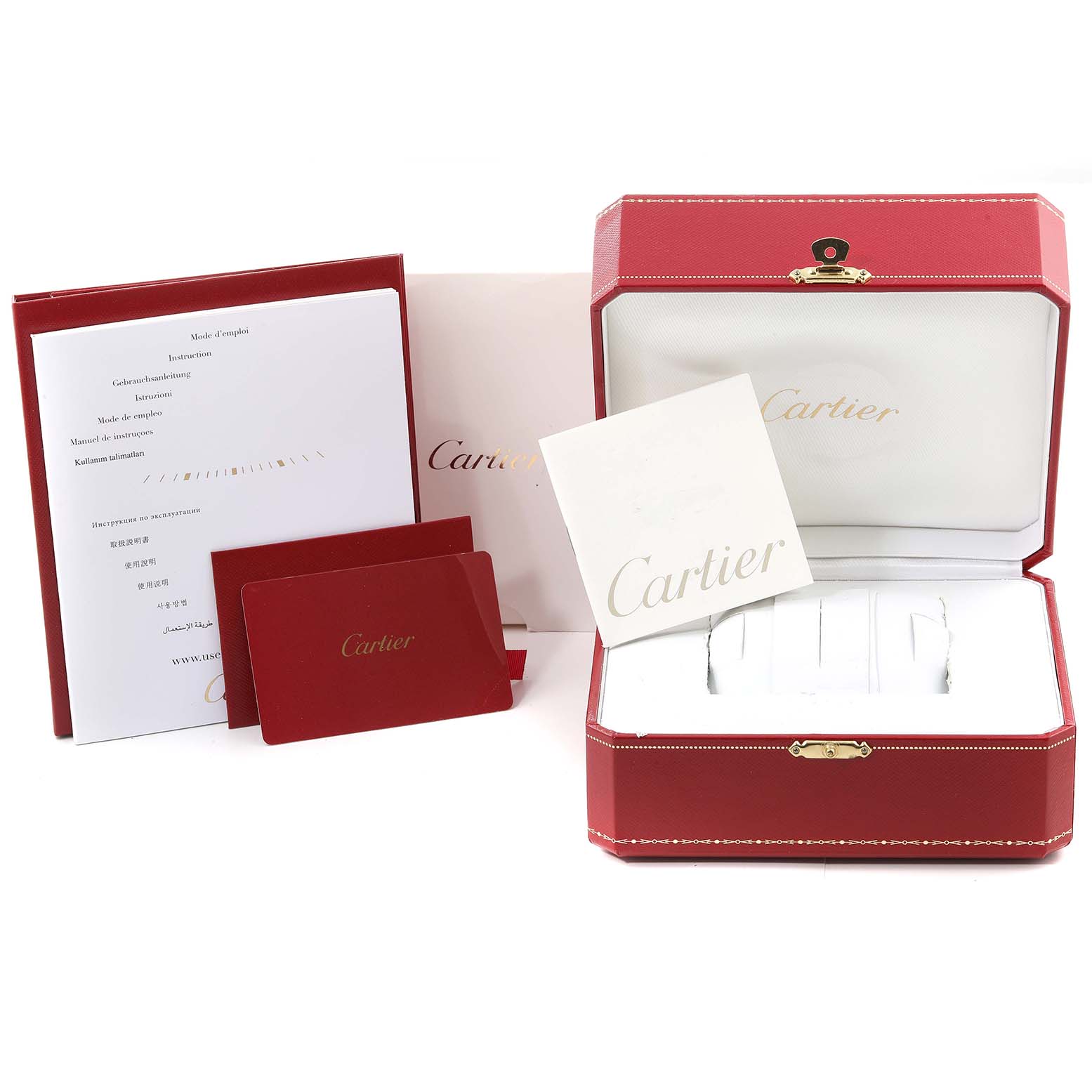 The image shows the packaging, manuals, and warranty cards for the Calibre de Cartier model by Cartier.