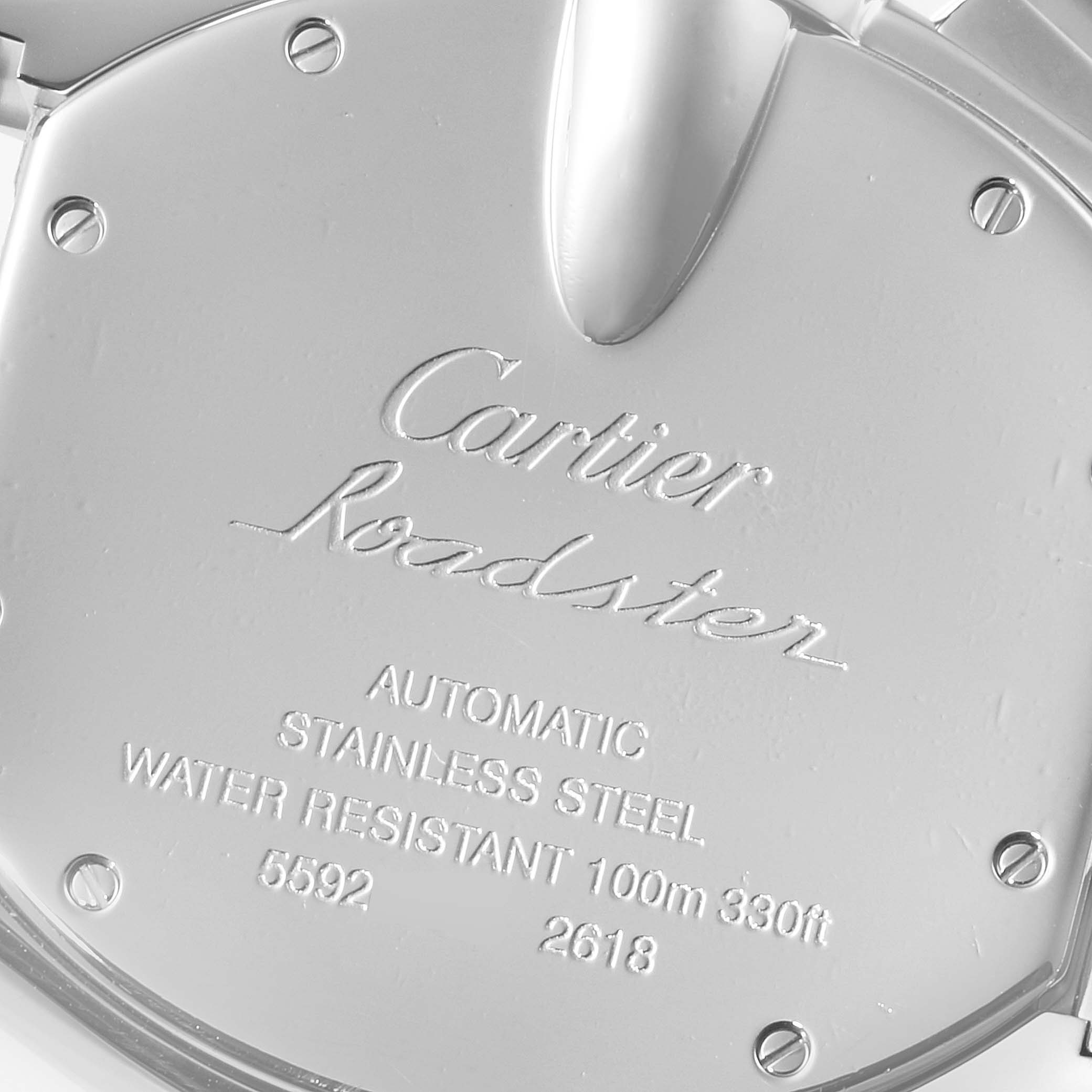 The image shows the back case of a Cartier Roadster W62019X6 Men
s Stainless Steel Silver Dial W62019X6 Men
s Stainless Steel Silver Dial watch, highlighting its engravings and specifications.