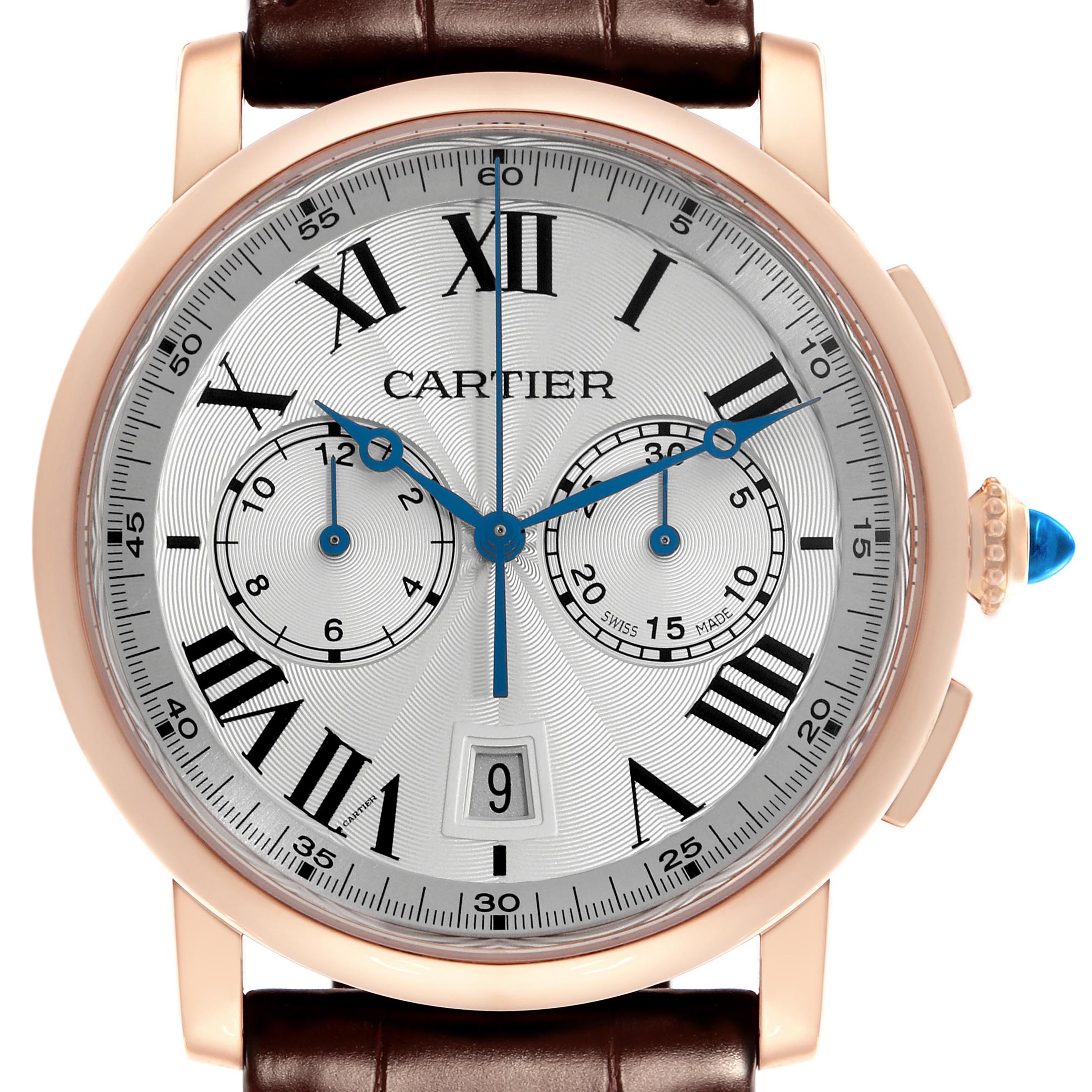 The Cartier Rotonde W1556238 Men
s Rose Gold Silver Dial W1556238 Men
s Rose Gold Silver Dial watch is shown from the front, highlighting its dial, Roman numerals, subdials, and crown with a blue gem.