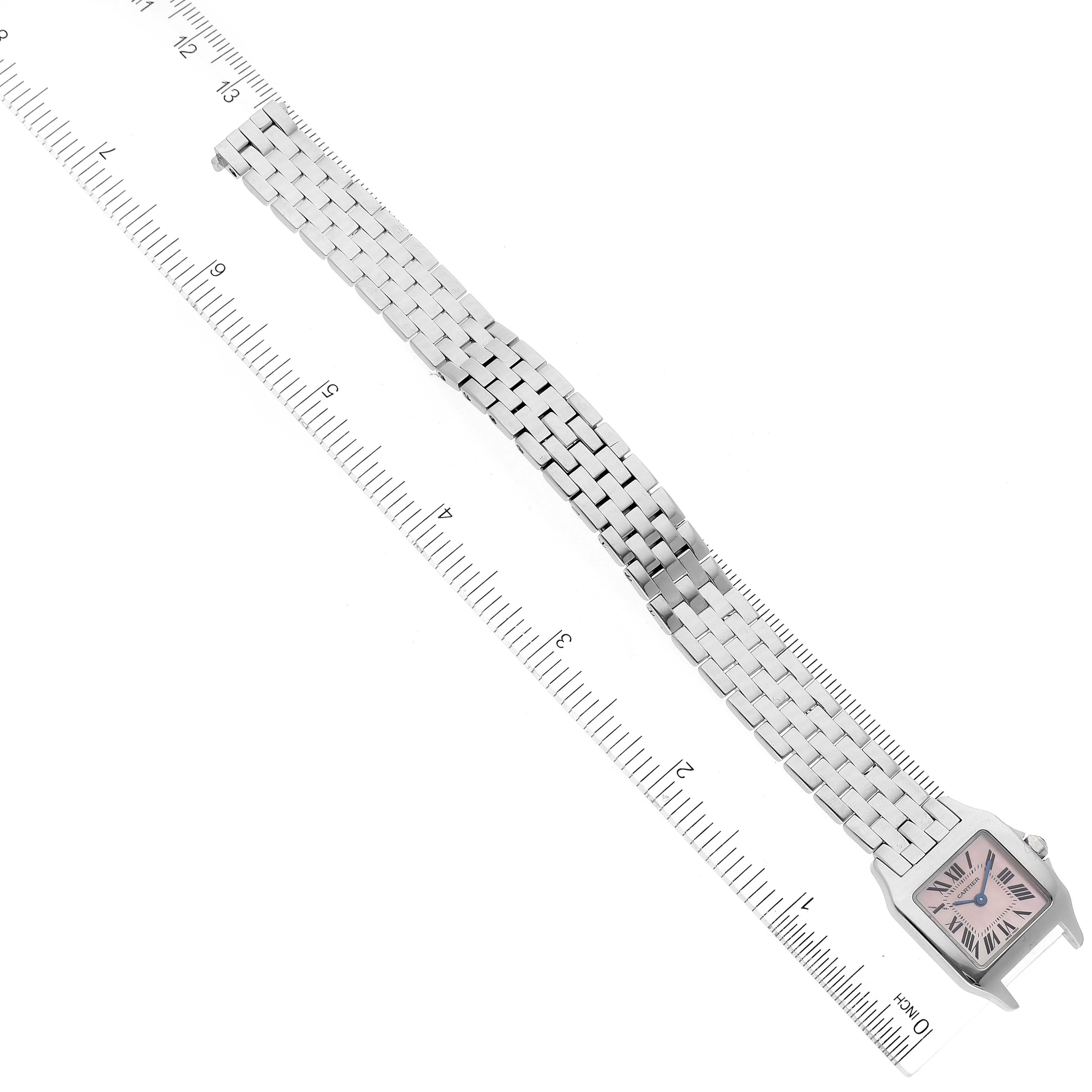 The image shows the full length of the Santos Demoiselle model by Cartier, including the face, case, and bracelet, measured against a ruler.