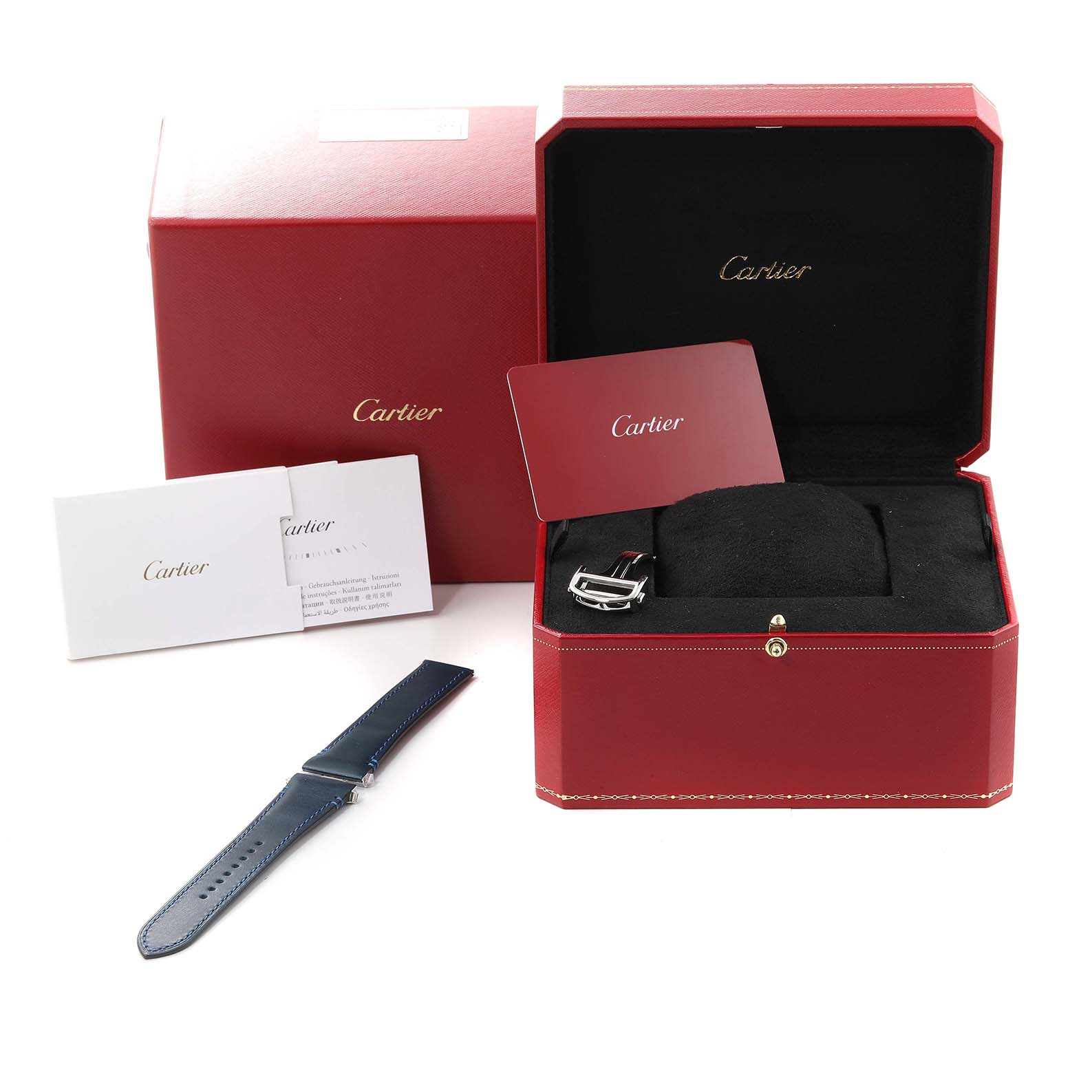 The image shows a Cartier Santos WSSA0030 Men
s Stainless Steel Blue Dial WSSA0030 Men
s Stainless Steel Blue Dial watch box open, displaying the interior cushion, a card, and an additional strap.