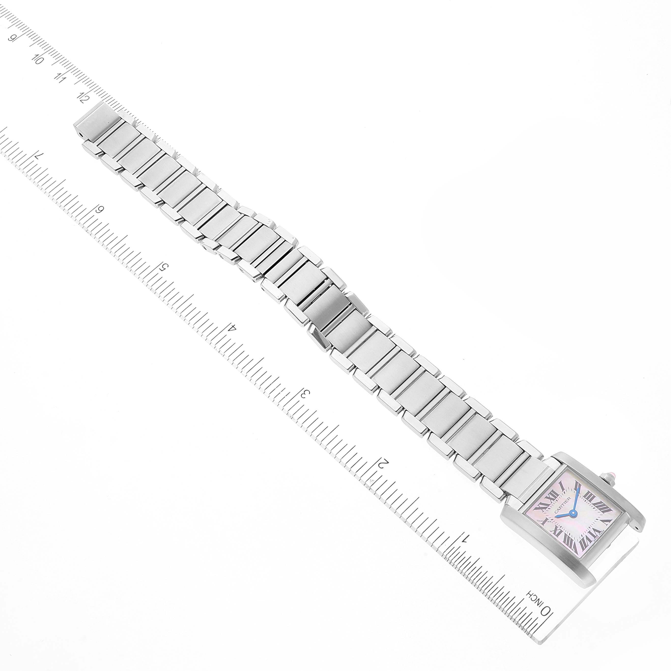 The image shows a top-down view of a Cartier Tank Francaise W51028Q3 Women's Stainless Steel Mother of Pearl Dial W51028Q3 Women's Stainless Steel Mother of Pearl Dial watch with its full metal bracelet aligned alongside a ruler.