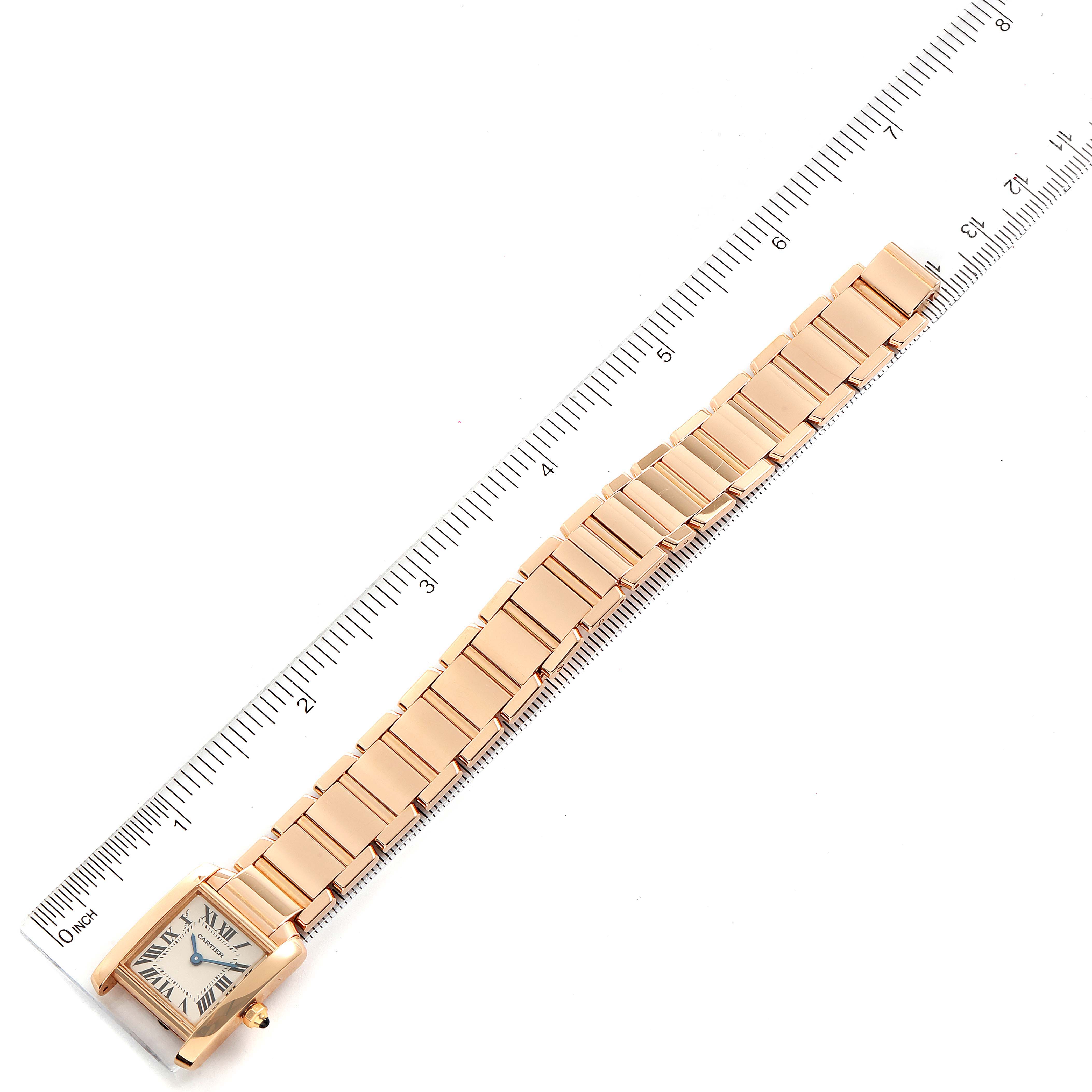 The Cartier Tank Francaise 2793 Women's Rose Gold Silver Dial 2793 Women's Rose Gold Silver Dial watch is shown from an overhead angle, alongside a ruler for scale.
