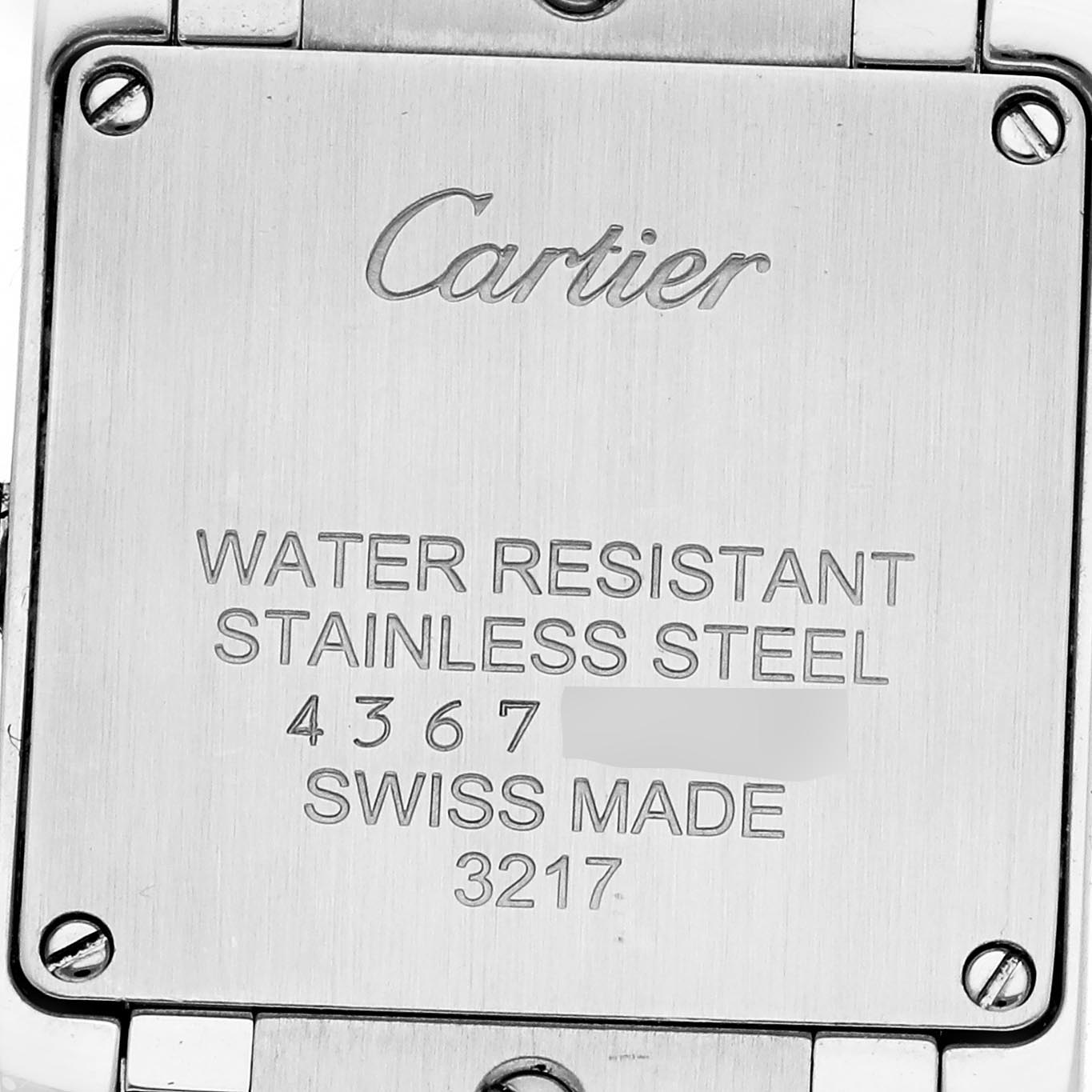 The image shows the back of a Cartier Tank Française watch, highlighting the stainless steel case and engraved details.