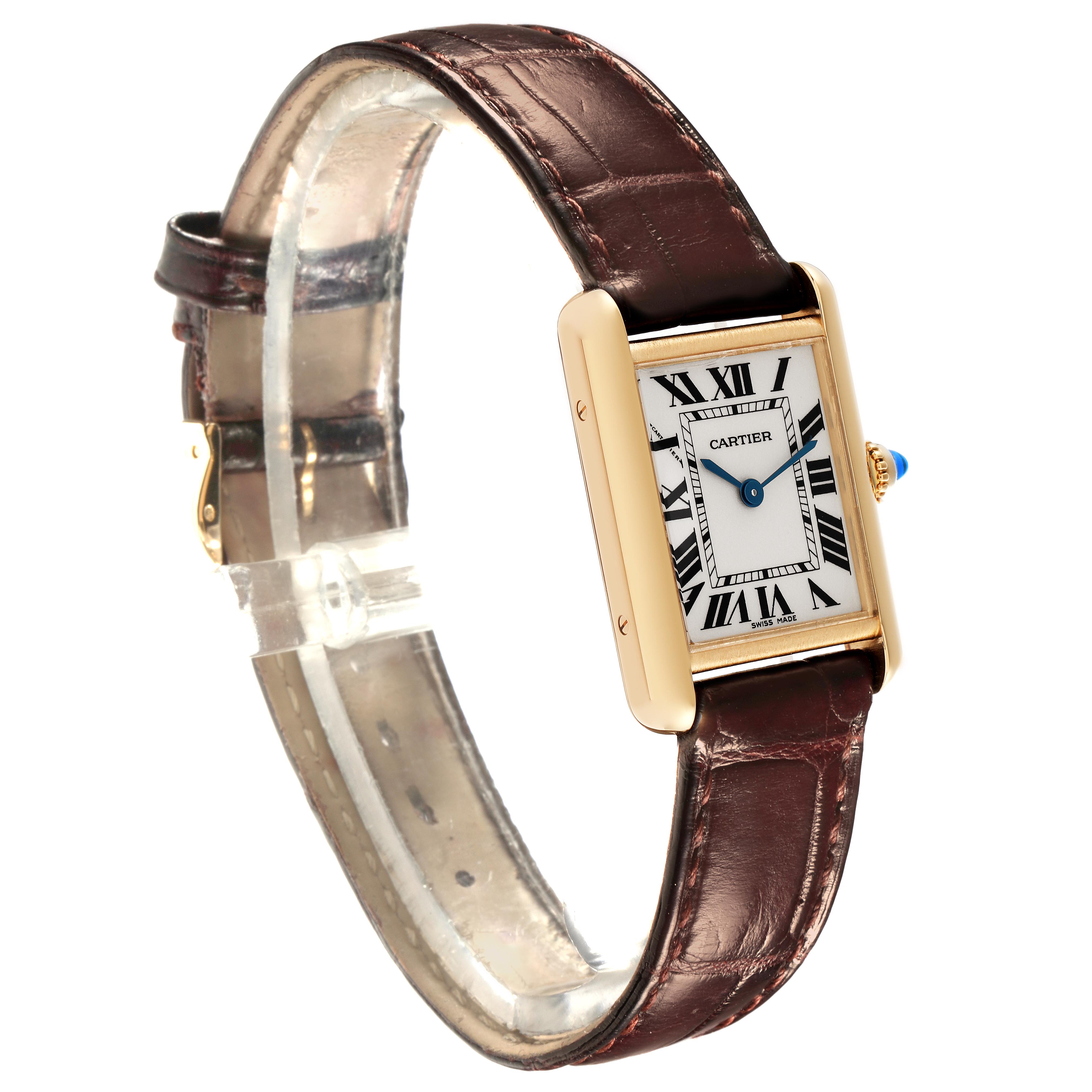 The Cartier Tank Louis W1529856 Women
s Yellow Gold Silver Dial W1529856 Women
s Yellow Gold Silver Dial watch is shown at a slight angle, highlighting the face, gold case, and brown leather strap.