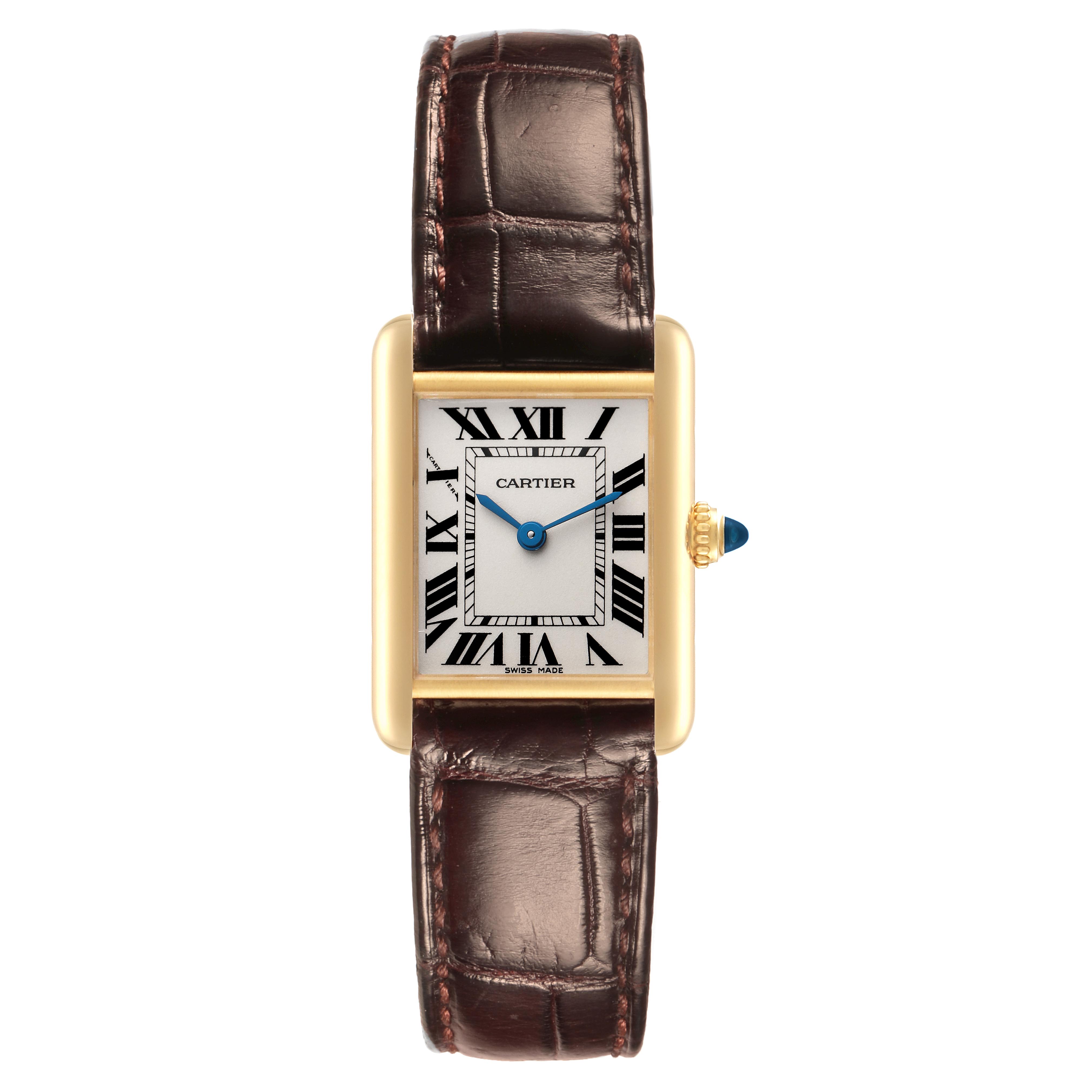The Cartier Tank Louis W1529856 Women
s Yellow Gold Silver Dial W1529856 Women
s Yellow Gold Silver Dial watch is shown from the front, featuring its rectangular gold case, brown leather strap, and blue hands.