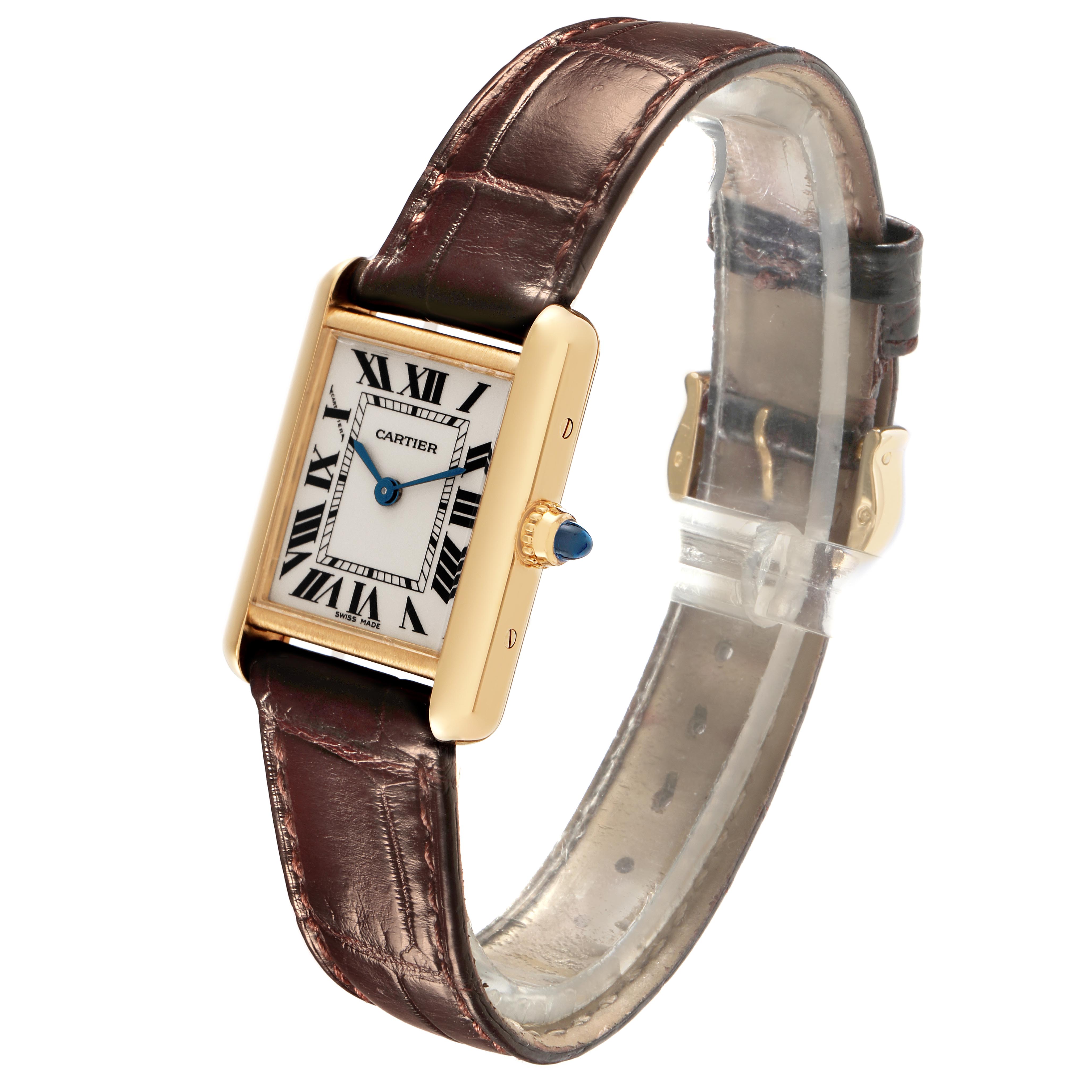 The Cartier Tank Louis W1529856 Women
s Yellow Gold Silver Dial W1529856 Women
s Yellow Gold Silver Dial watch is shown at a slight angle, highlighting the face, crown, and brown leather strap.