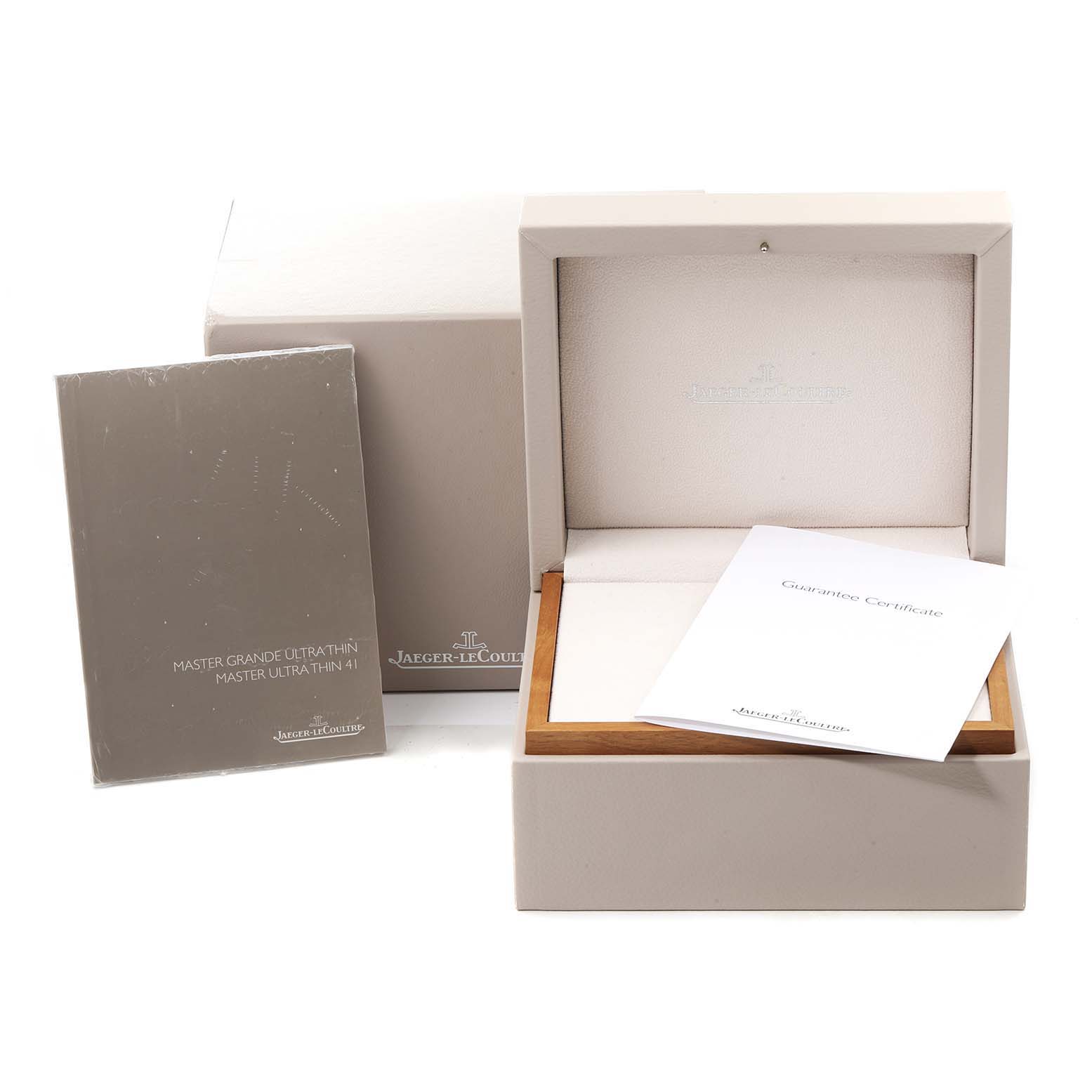 The image shows the packaging and accessories for the Jaeger-LeCoultre Master model watch, including its box and guarantee certificate.