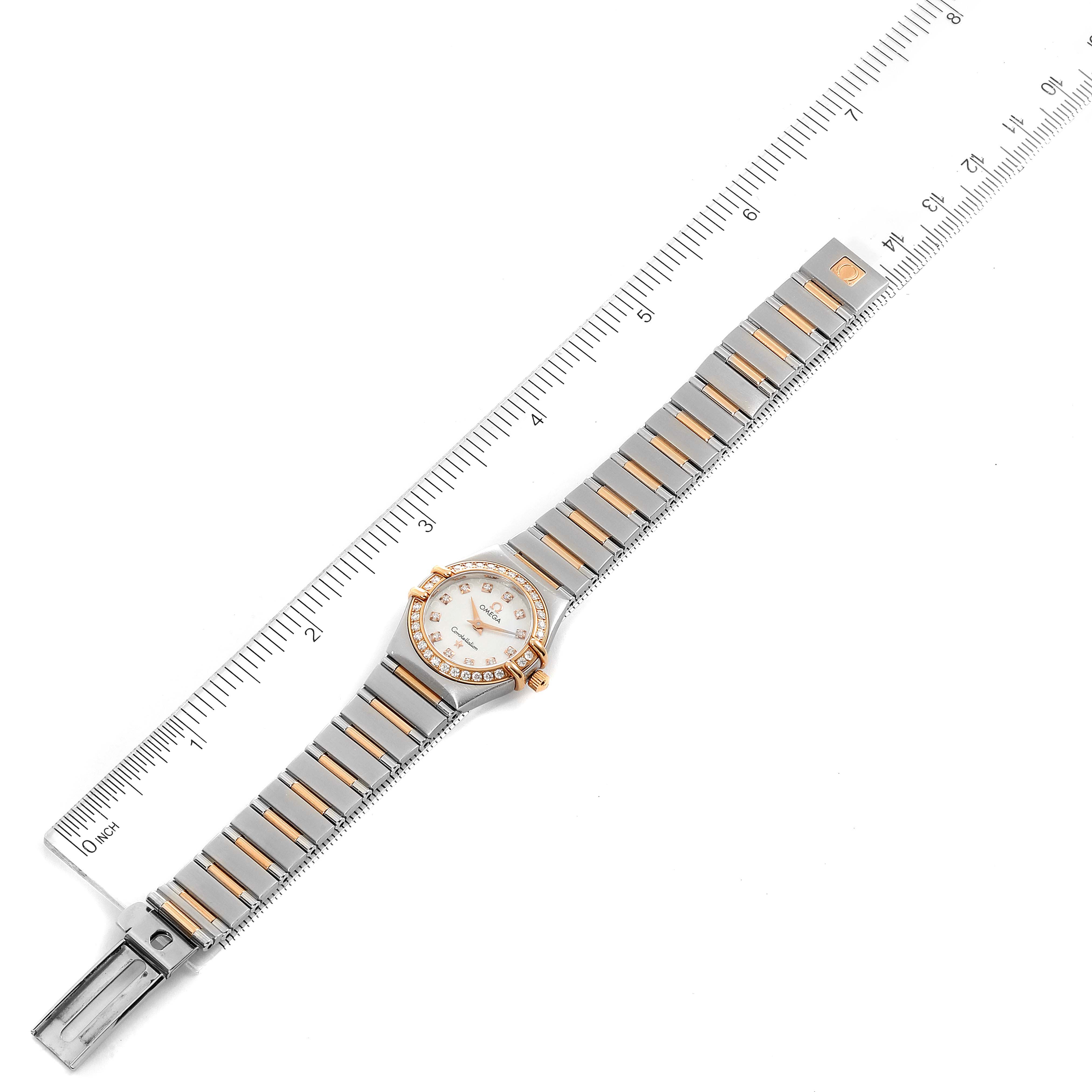 The image shows a top view of the Omega 1360.75.00 Women's Steel and Gold (two tone) Mother of Pearl Dial 1360.75.00 Women's Steel and Gold (two tone) Mother of Pearl Dial Constellation My Choice Steel Rose Gold Diamond Ladies Watch 1360.75.00 placed next to a ruler.