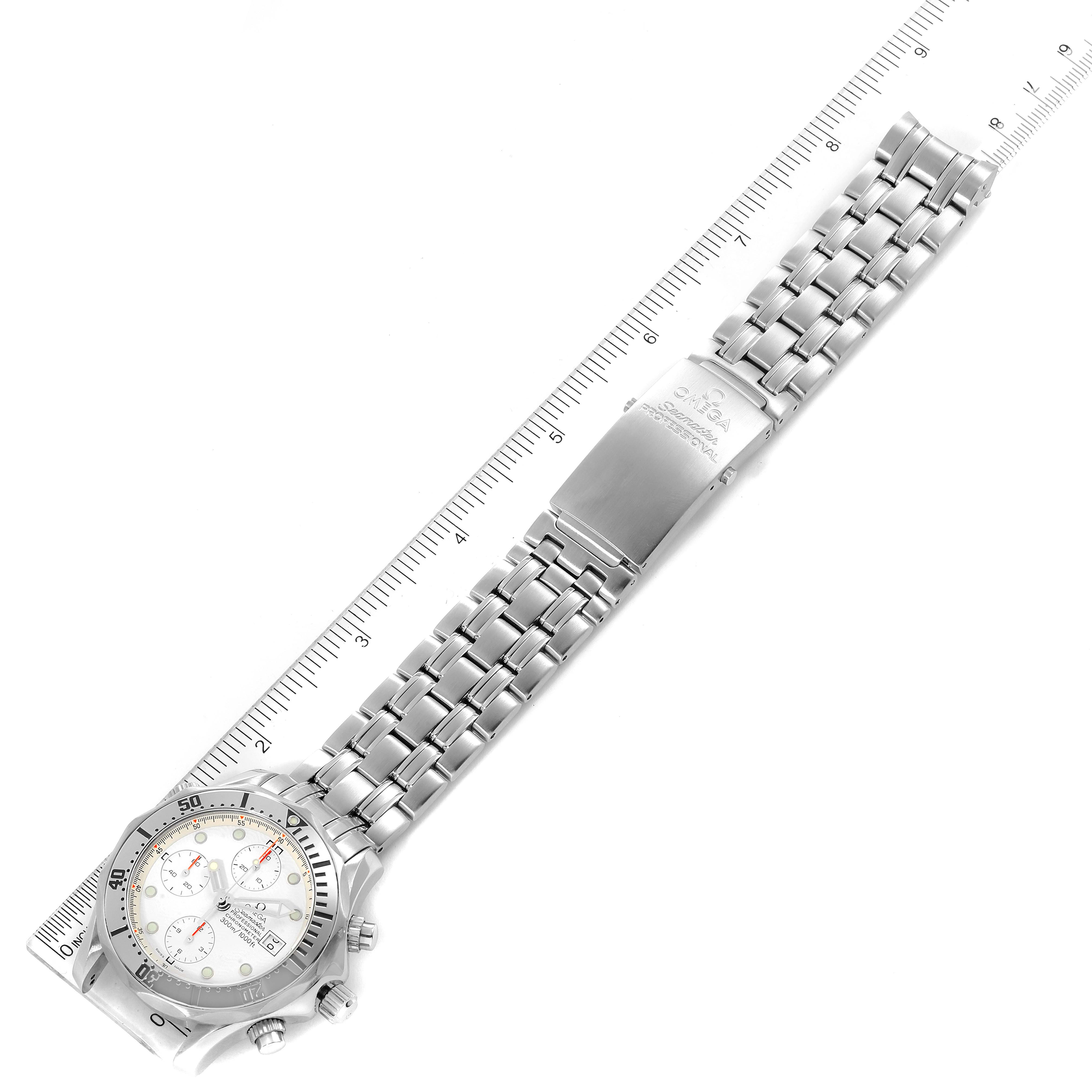 This image shows an Omega Seamaster 2598.20.00 Men
s Stainless Steel White Dial 2598.20.00 Men
s Stainless Steel White Dial watch laid flat on its bracelet next to a ruler, showcasing the entire timepiece.