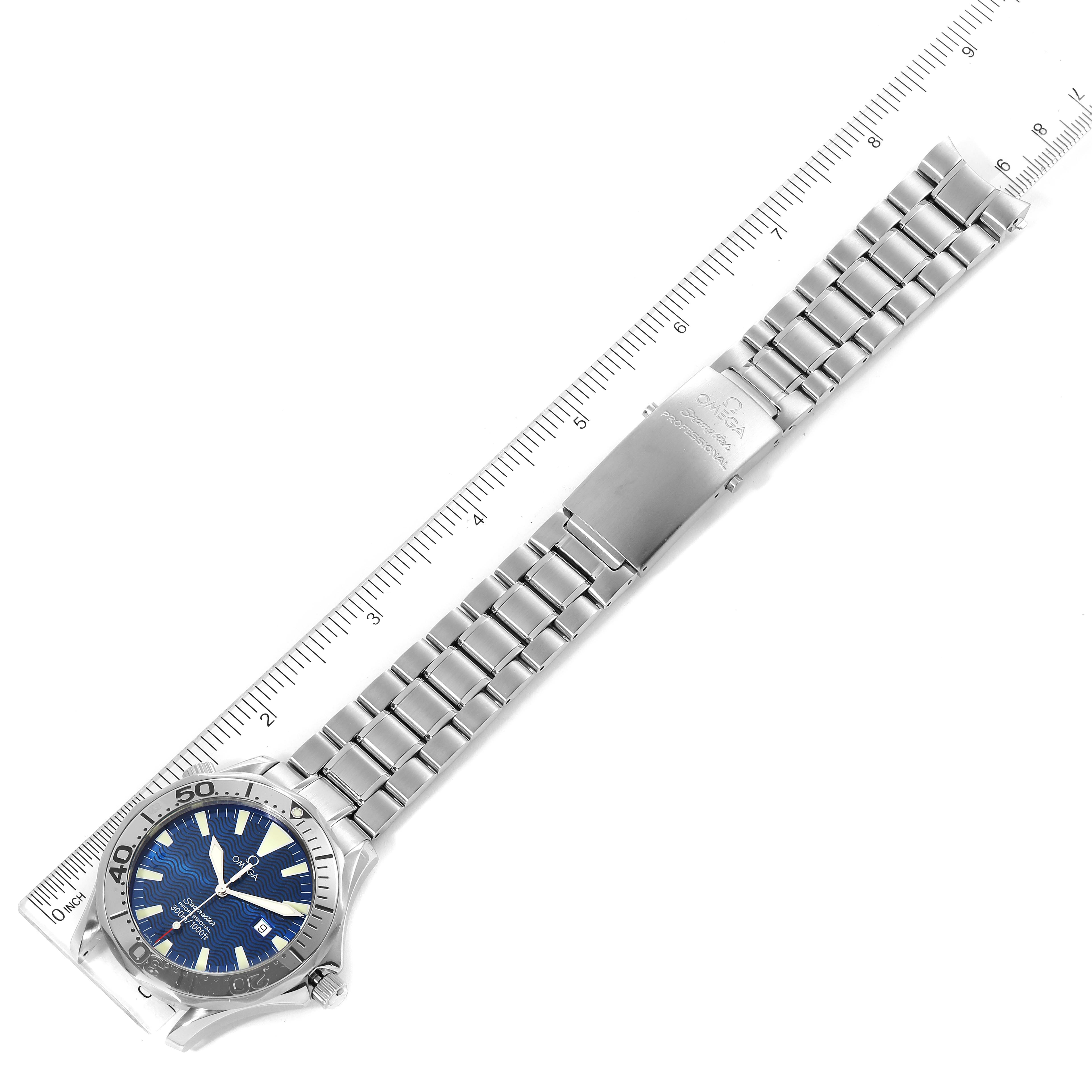 The image shows an Omega Seamaster 2265.80.00 Men
s Stainless Steel Blue Dial 2265.80.00 Men
s Stainless Steel Blue Dial watch laid flat from the front angle, including the watch face, bracelet, and clasp, alongside a ruler for scale.