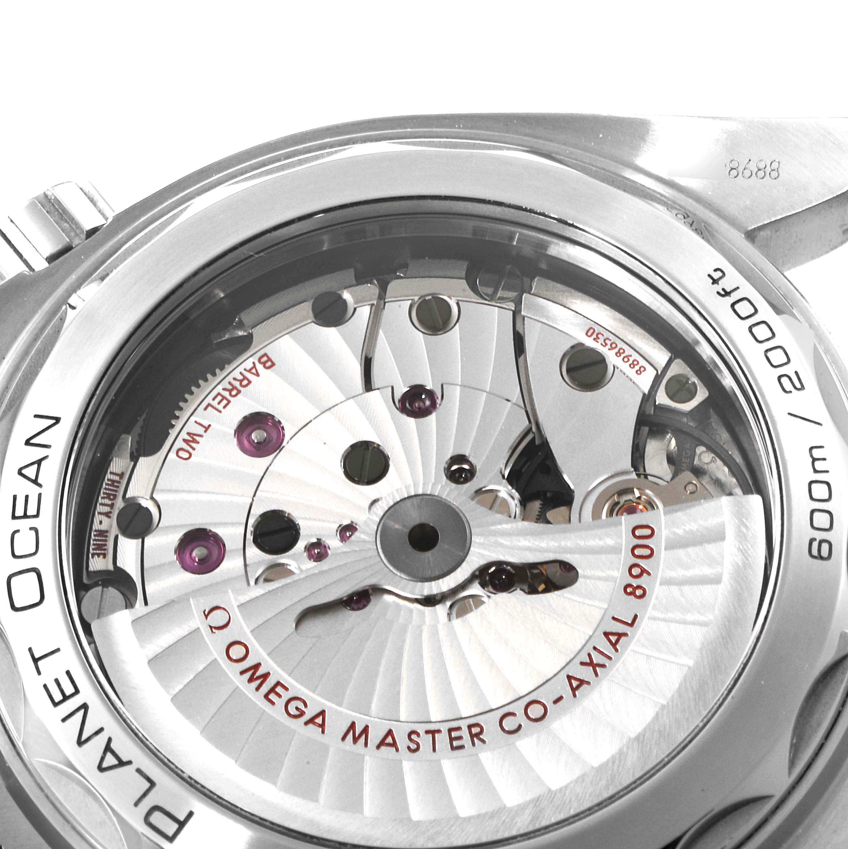 The image shows the back view of the Omega Planet Ocean 215.30.44.21.01.001 Men
s Stainless Steel Black Dial 215.30.44.21.01.001 Men
s Stainless Steel Black Dial watch, highlighting the internal mechanisms and engravings.