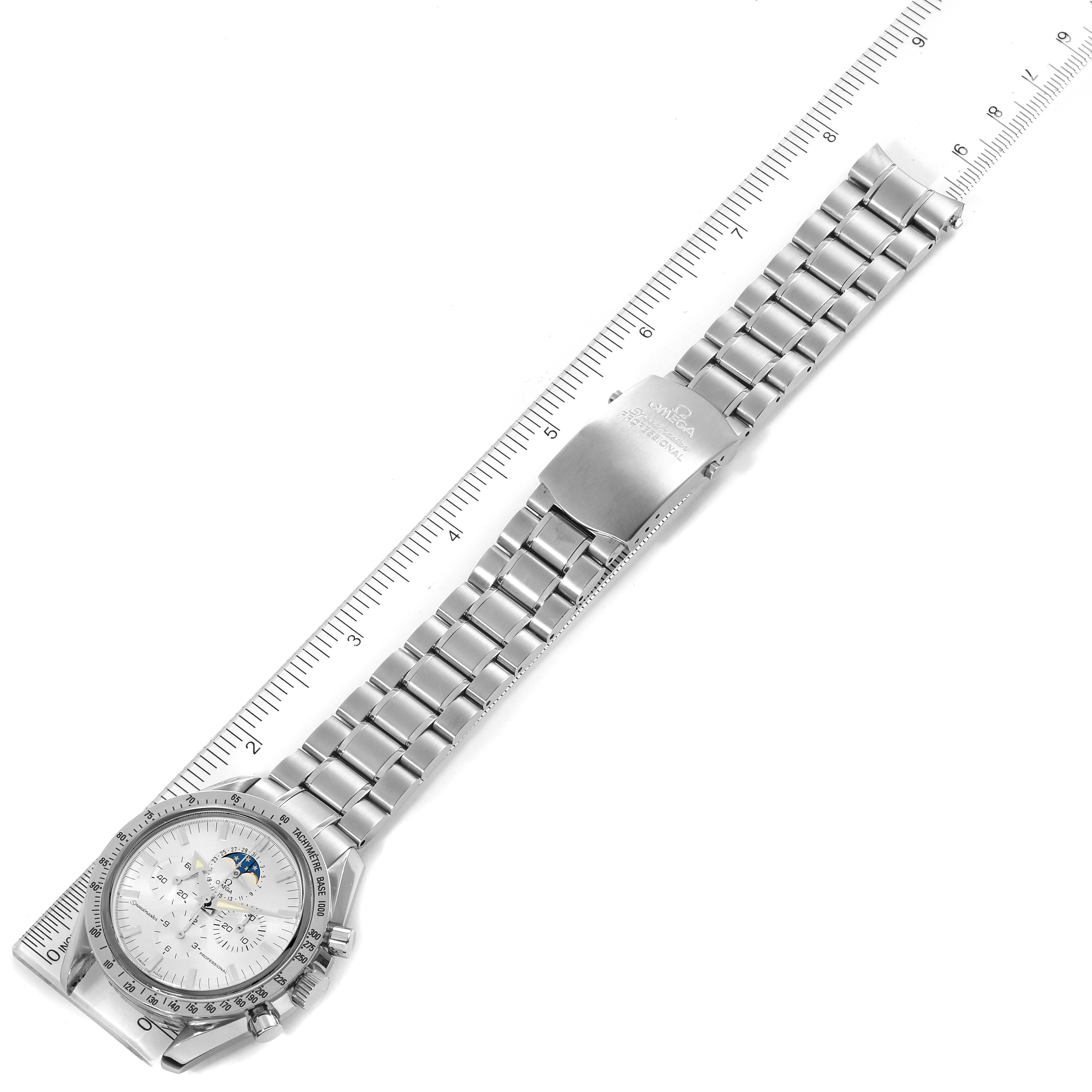 The image shows an Omega Speedmaster 3575.30.00 Men
s Stainless Steel Silver Dial 3575.30.00 Men
s Stainless Steel Silver Dial watch laid flat with a ruler for scale, displaying the full bracelet and watch face.