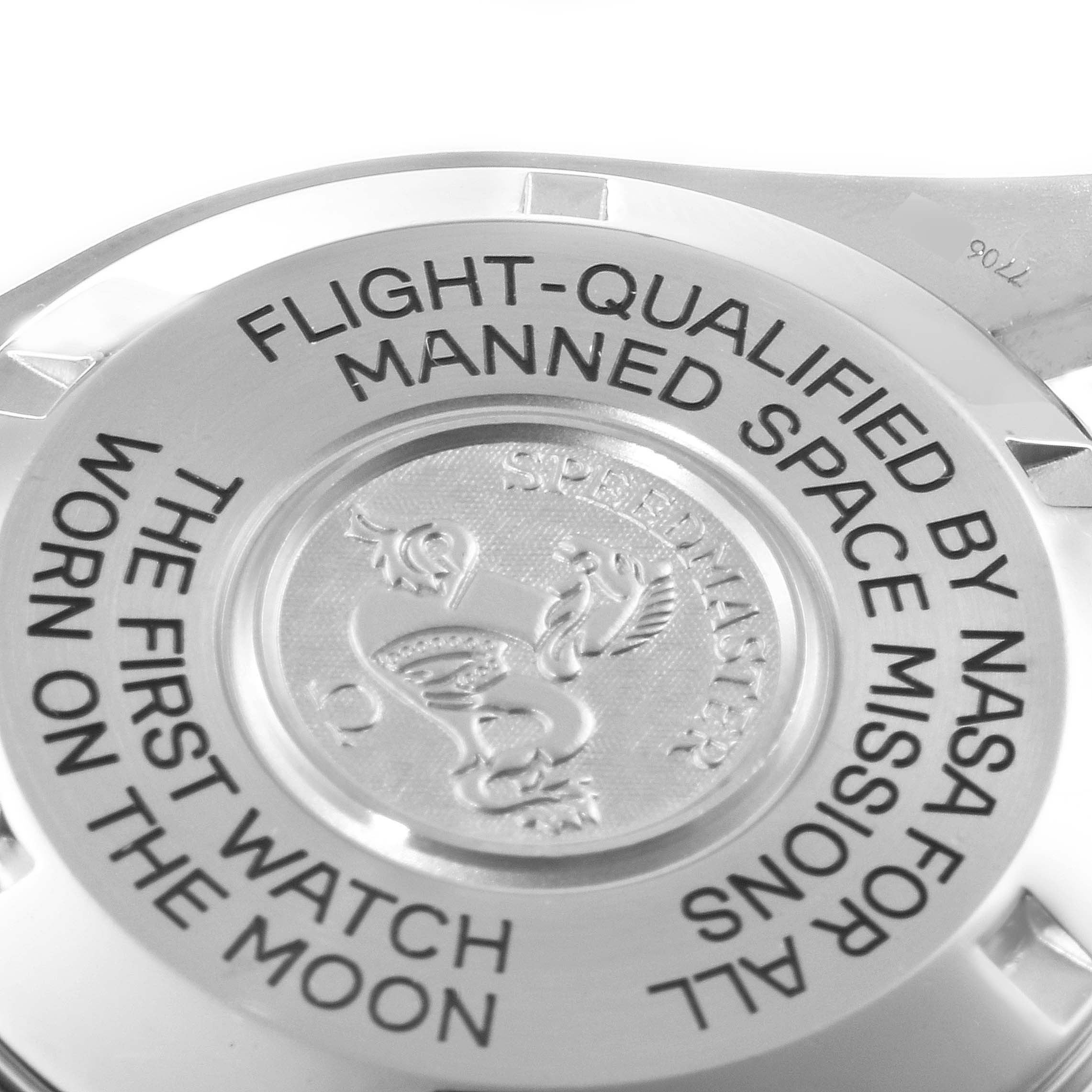 This image shows the back of an Omega Speedmaster 3575.30.00 Men
s Stainless Steel Silver Dial 3575.30.00 Men
s Stainless Steel Silver Dial watch, highlighting its engraved text and emblem.