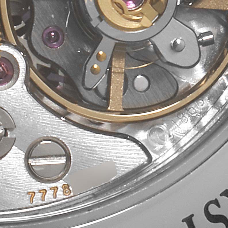 The image shows a close-up view of the internal mechanism of an Omega Speedmaster 311.30.42.30.01.006 Men
s Stainless Steel Black Dial 311.30.42.30.01.006 Men
s Stainless Steel Black Dial watch.