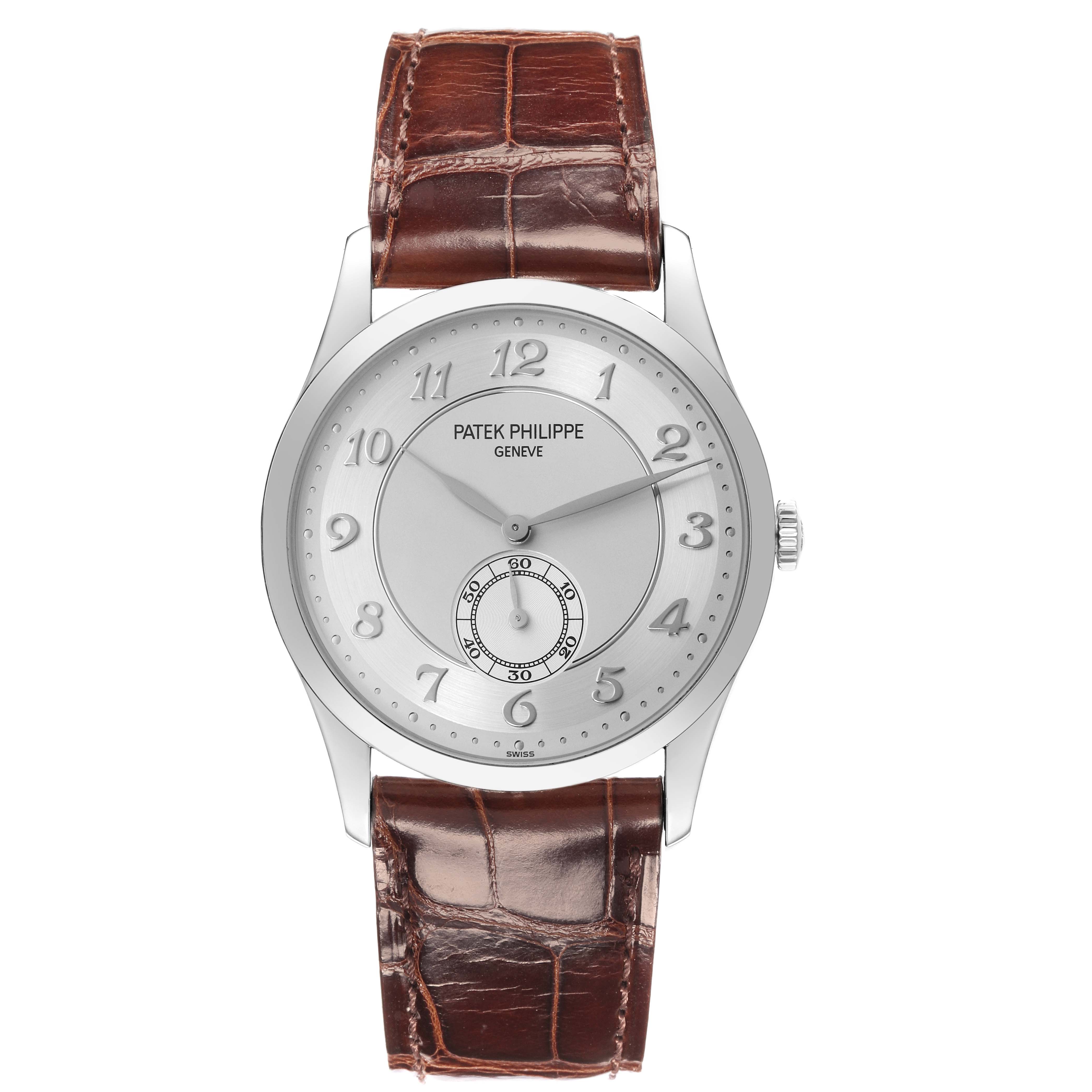The Patek Philippe Calatrava 5196P-001 Men's Platinum Silver Dial watch is shown from a top-down angle, displaying the dial, hands, and leather strap.