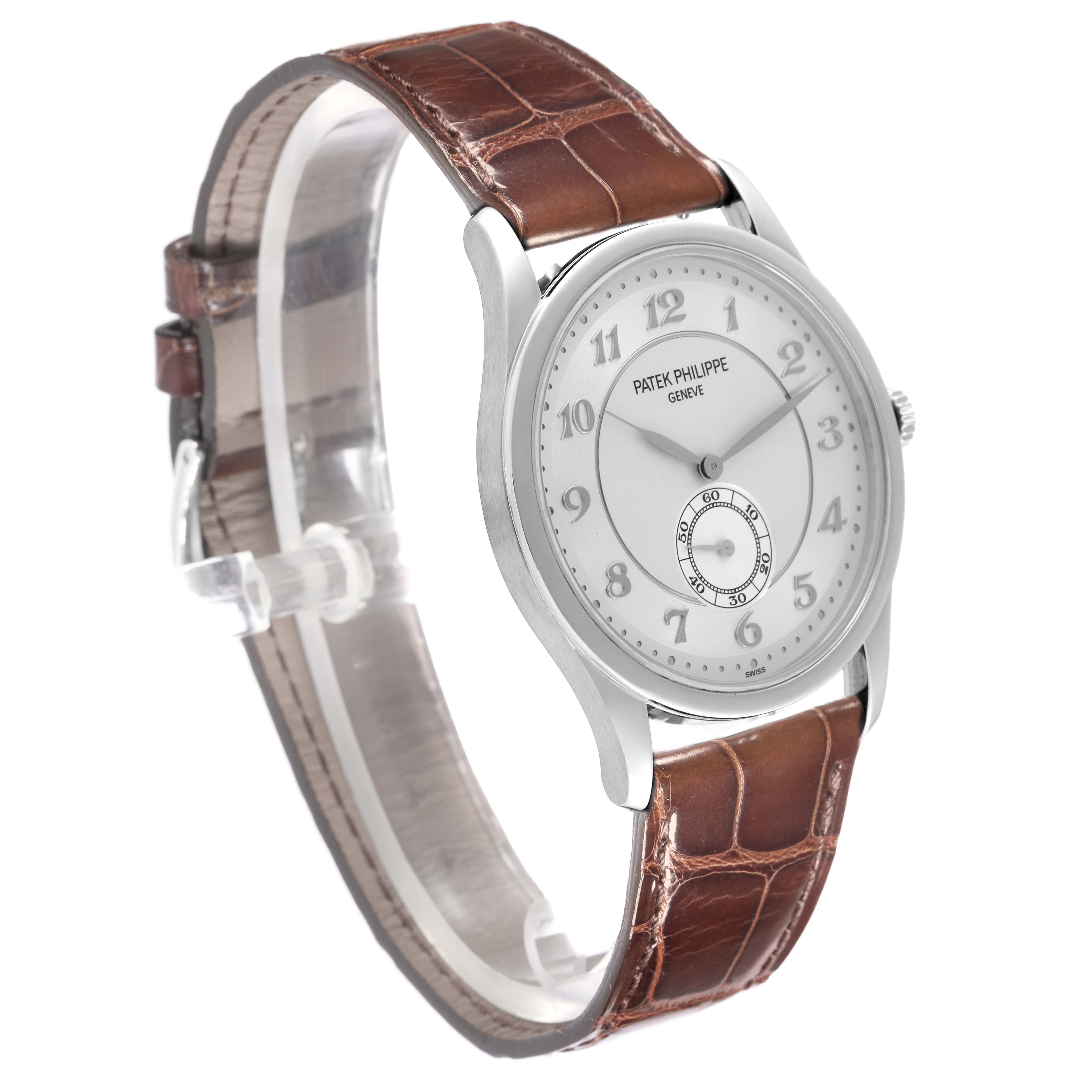 The Patek Philippe Calatrava 5196P-001 Men's Platinum Silver Dial watch is shown at a three-quarter angle, displaying the face, case, and brown leather strap.