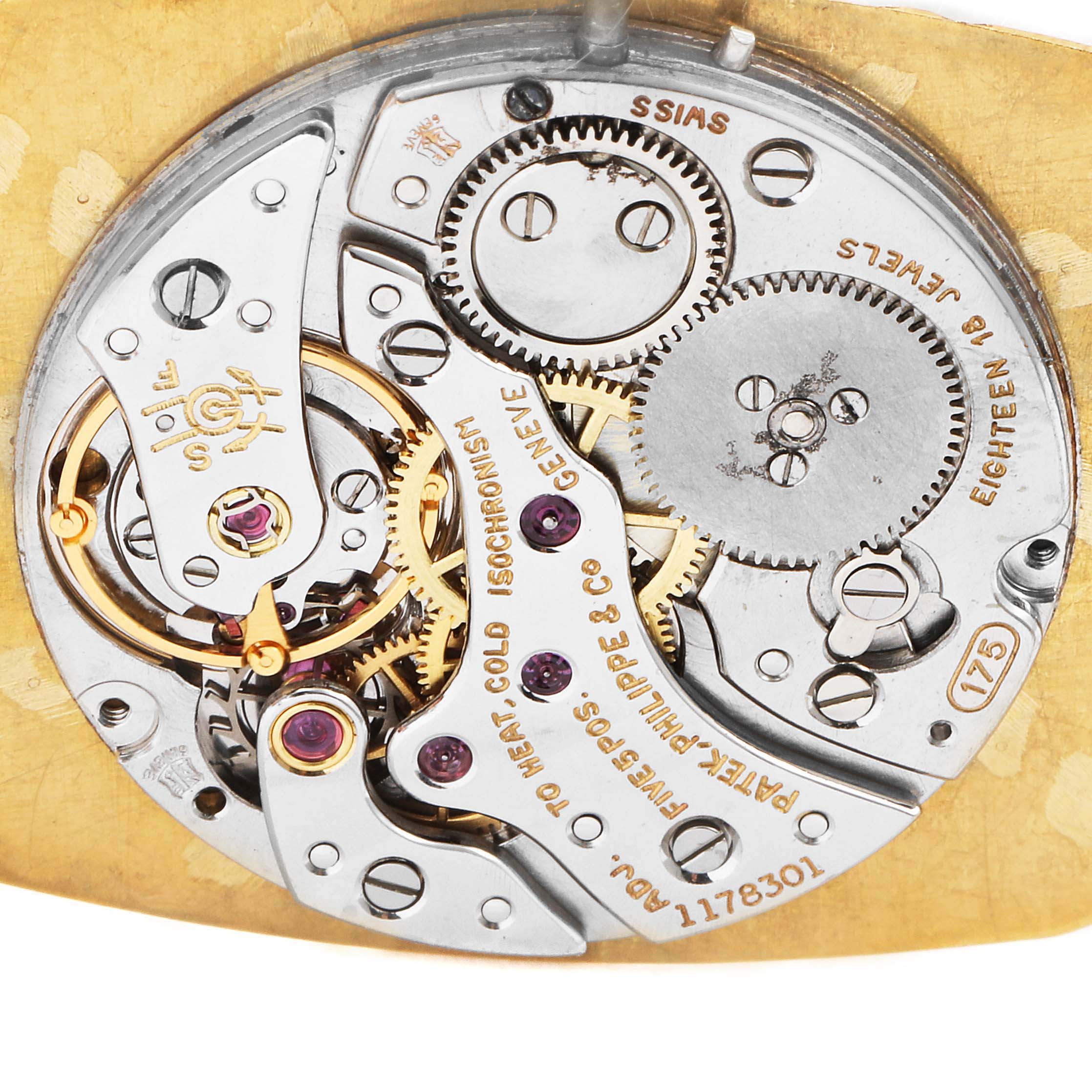This image shows the intricate inner mechanics of a vintage Patek Philippe watch, highlighting gears and engravings.