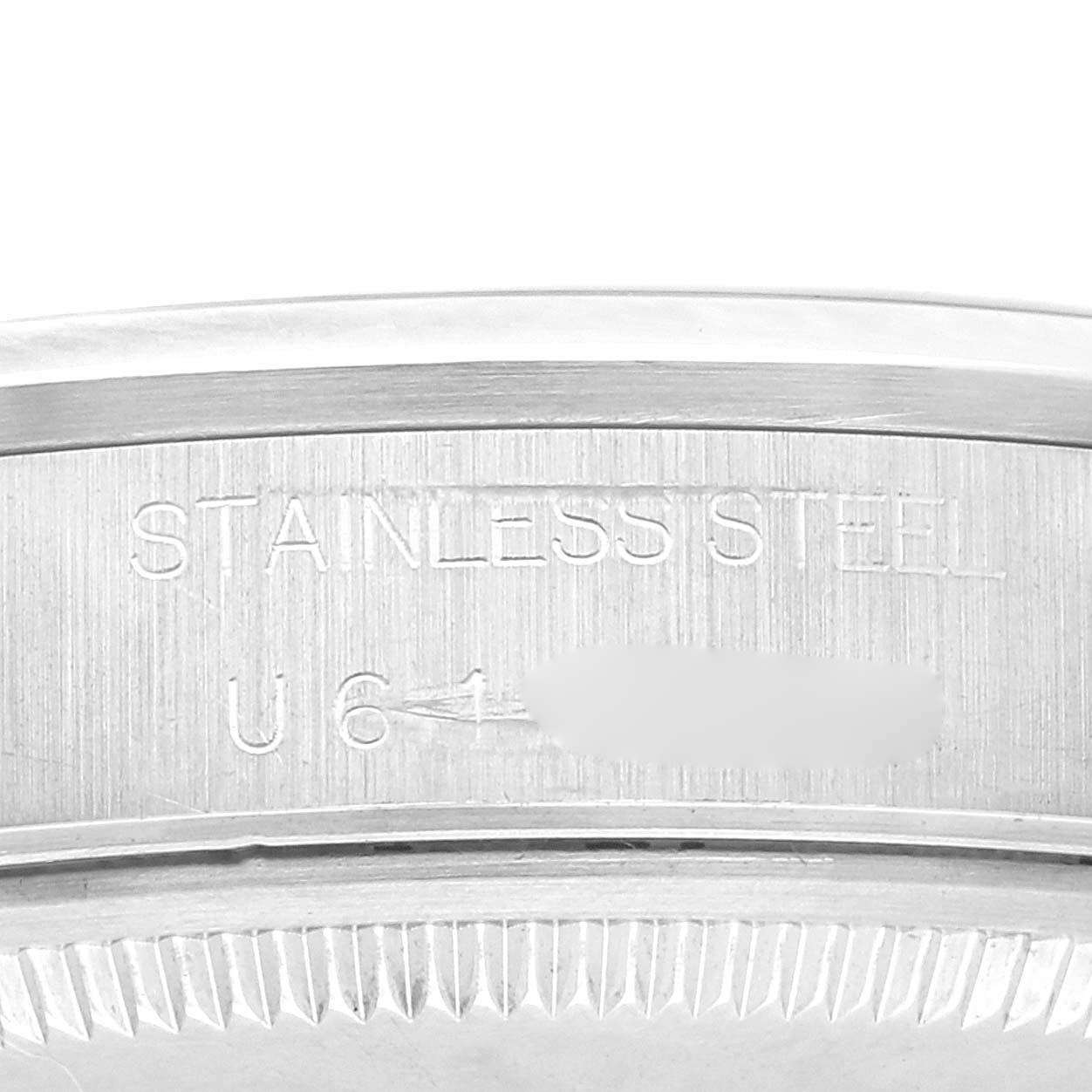 The image shows a close-up of the edge of the stainless steel case back of a Rolex Air-King 14000 Men's Stainless Steel Black Dial 14000 Men's Stainless Steel Black Dial watch.