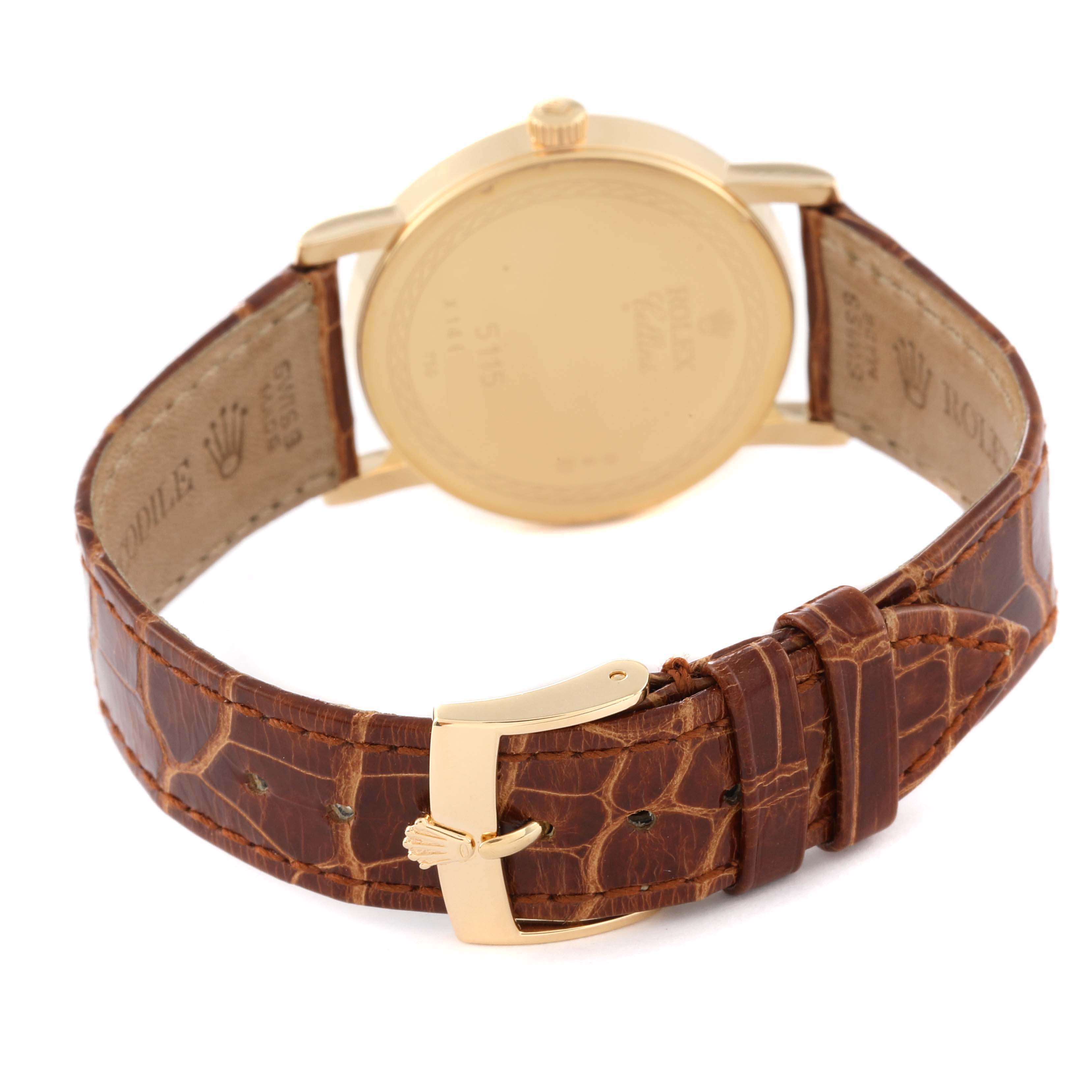 This image shows the back view of a Rolex Cellini 5115 Men's Yellow Gold Beige Dial 5115 Men's Yellow Gold Beige Dial watch emphasizing its leather strap and gold buckle.
