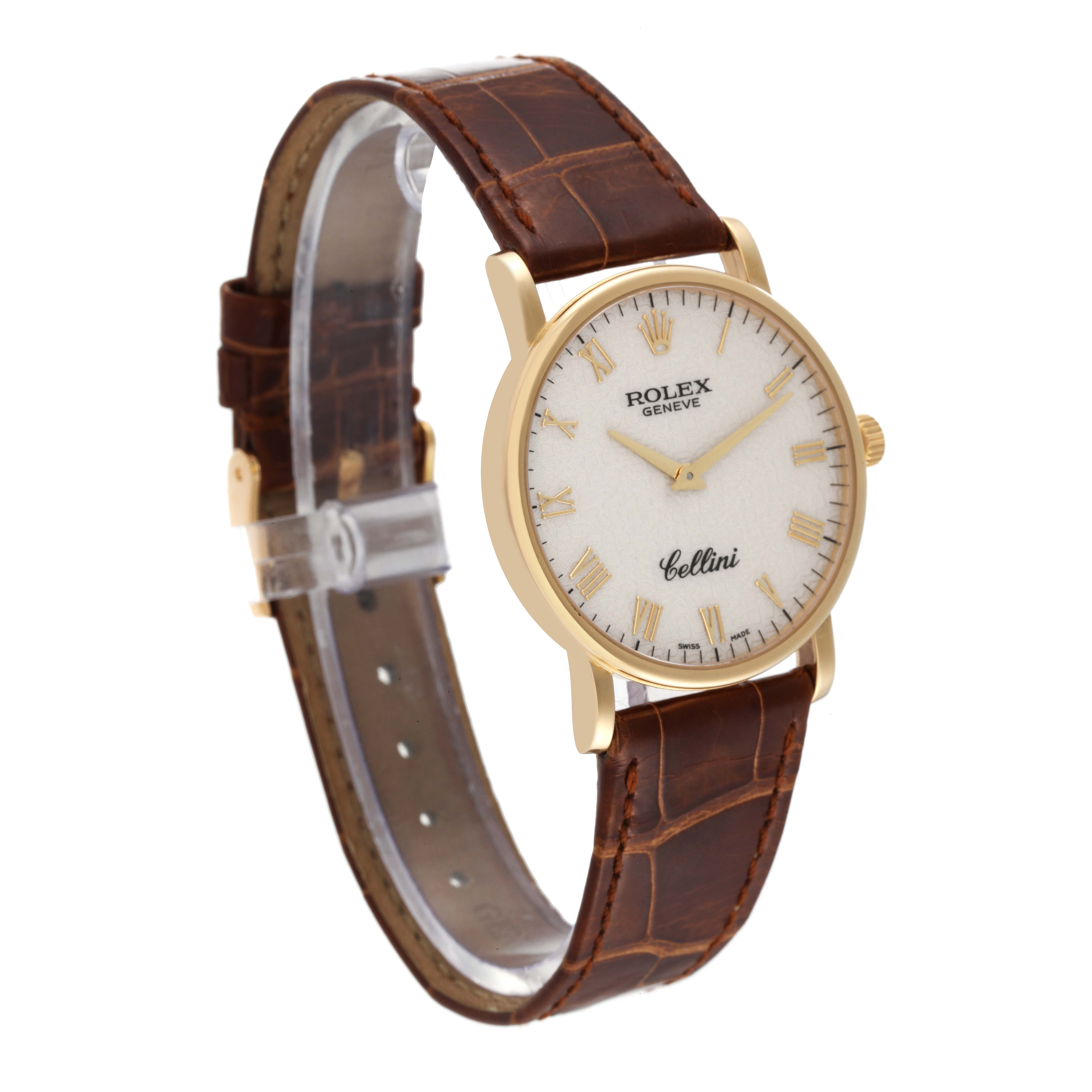 The Rolex Cellini 5115 Men's Yellow Gold Beige Dial 5115 Men's Yellow Gold Beige Dial watch is shown at a 3/4 angle, displaying its brown leather strap and gold case with a white dial.