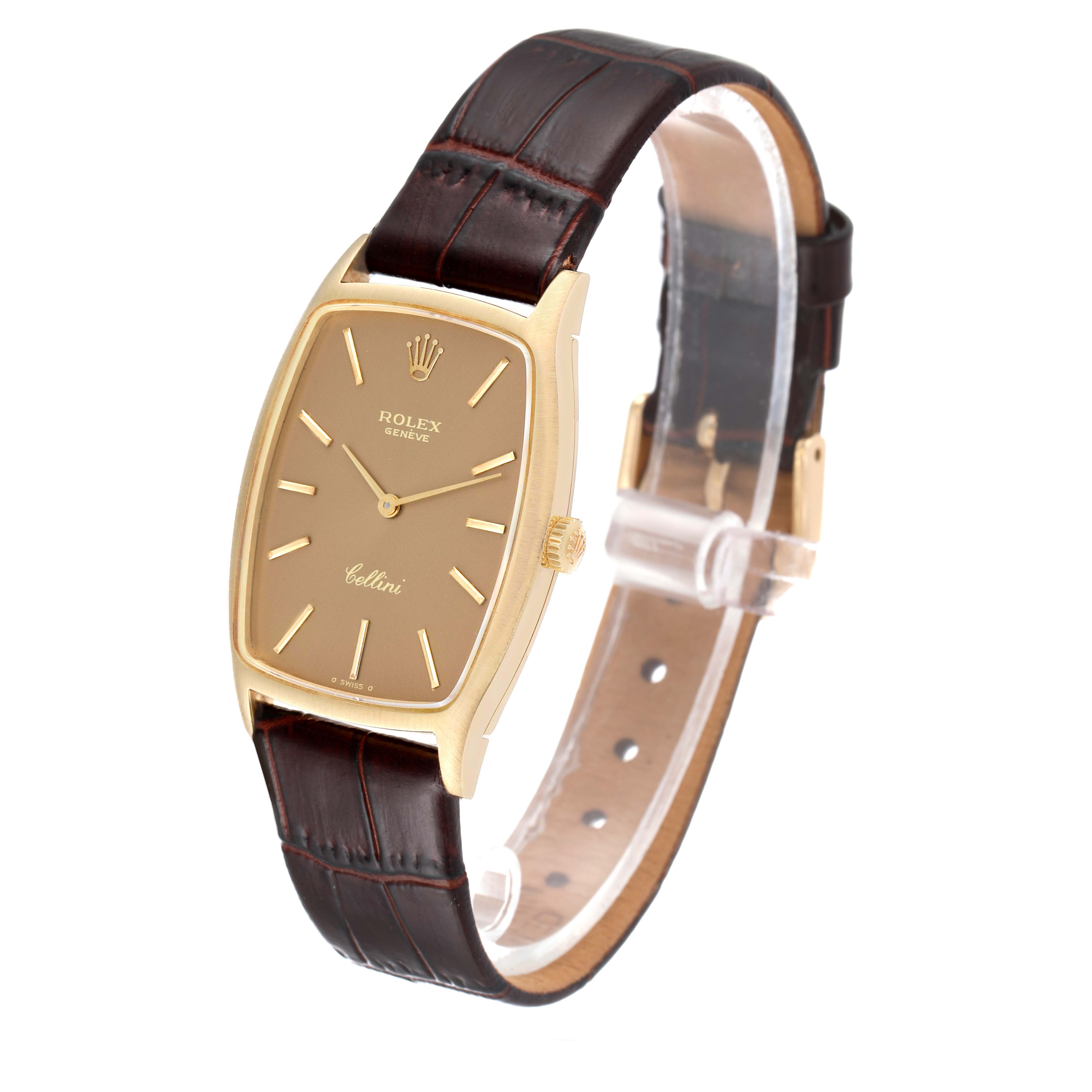 The Rolex Cellini 3807 Women's Yellow Gold Champagne Dial 3807 Women's Yellow Gold Champagne Dial watch is shown at a slight angle, featuring its rectangular dial, gold casing, and brown leather strap.