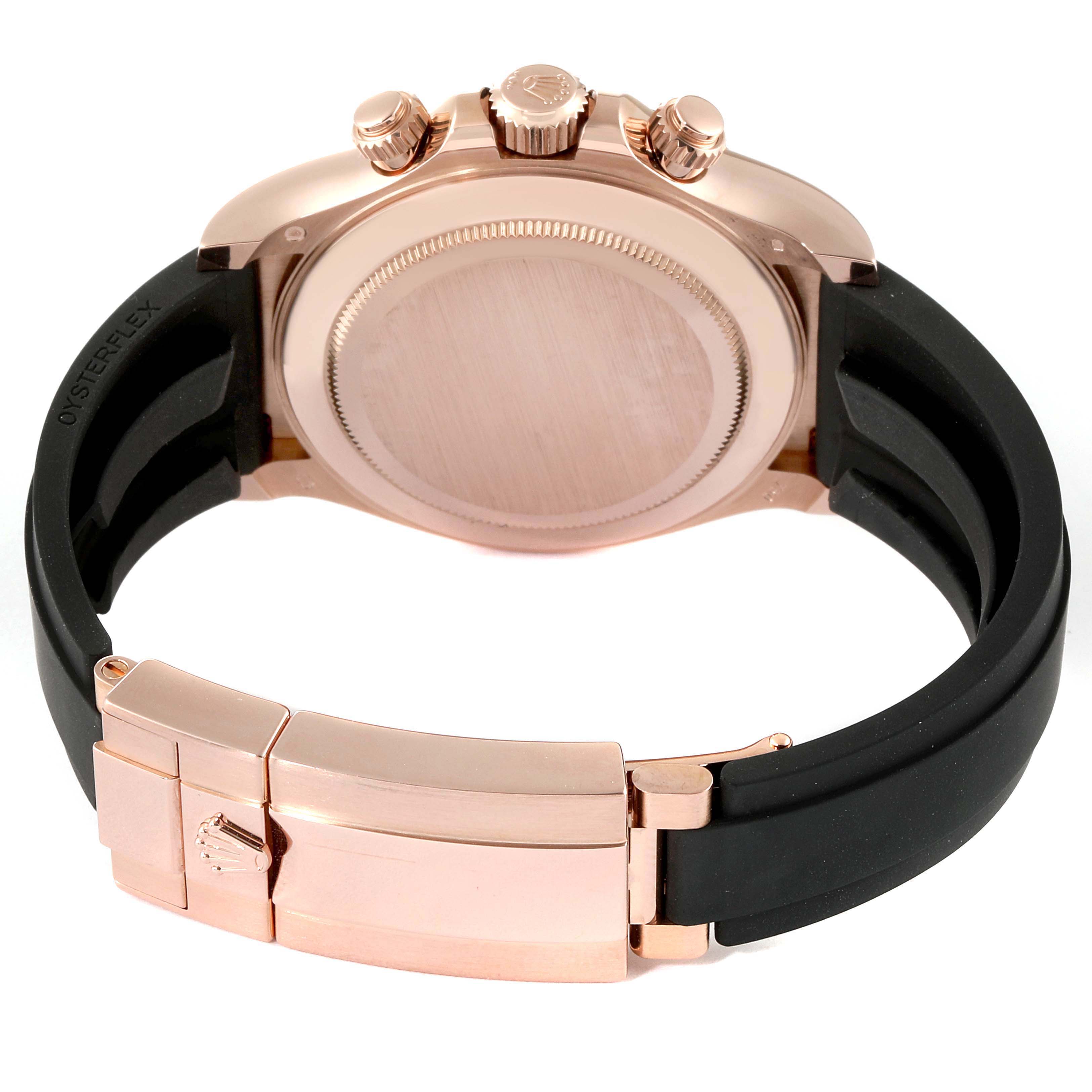 The image shows the back case, crown, chronograph pushers, and clasp of a Rolex Daytona 116515LN Men's Rose Gold  116515LN Men's Rose Gold  with a black band.